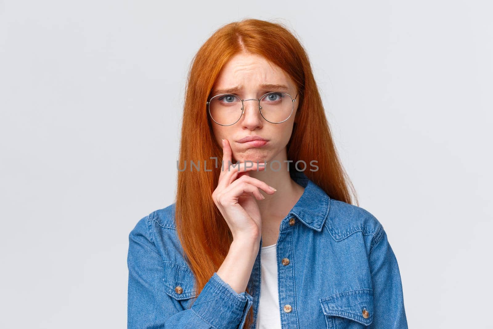 Uneasy, indecisive timid cute redhead girl dont know what do in future, deciding what college enter, having troubled with making choice, pouting and looking camera gloomy by Benzoix