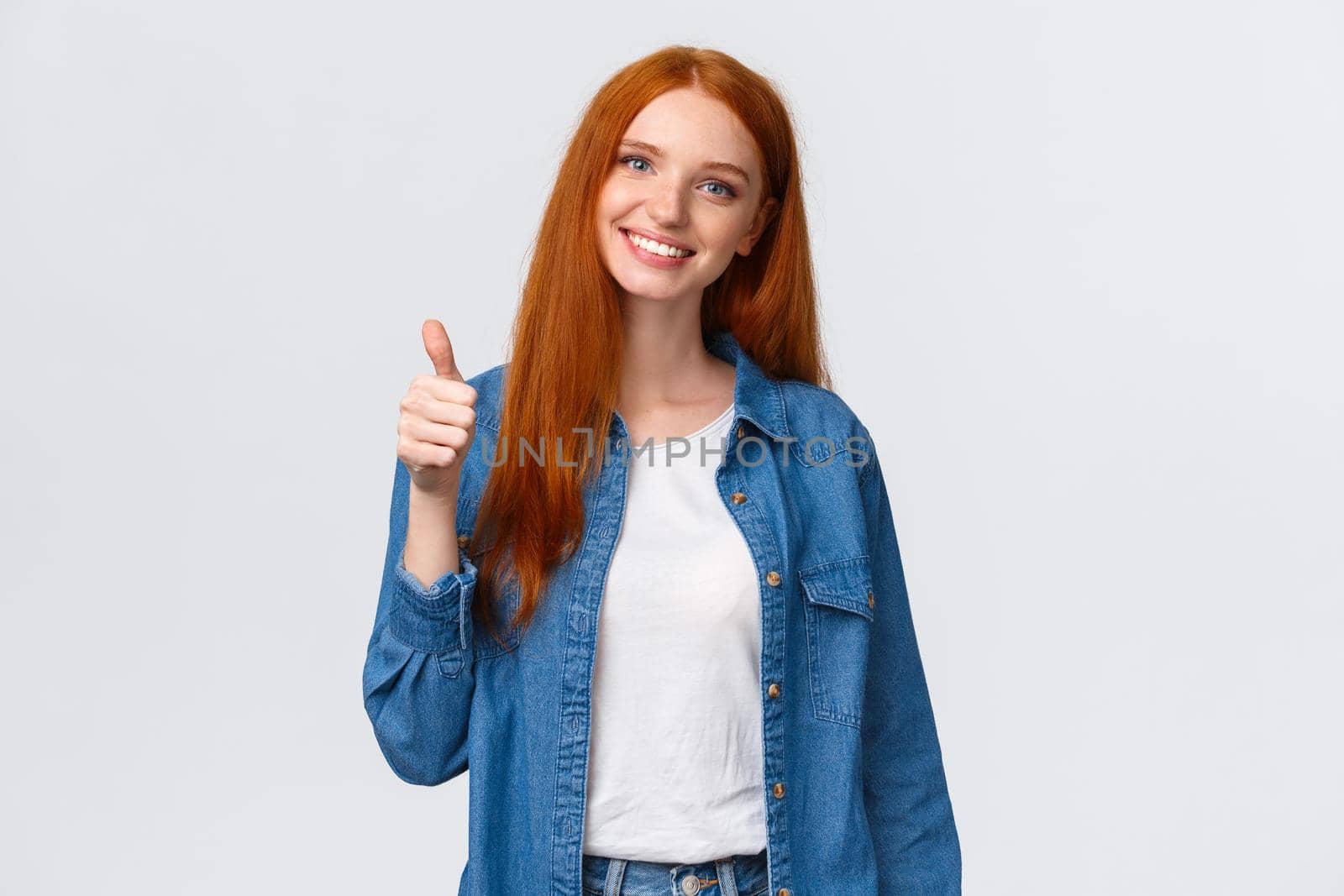 Well done, proud you. Attractive cheerful redhead caucasian girl blogger, review product, encourage friend keep up, showing thumb-up and smiling in approval, agree or like gesture, white background.