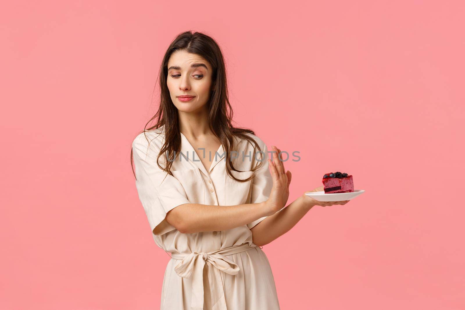 No thank you. Girl having strong will, reject piece cake, holding plate and making stop, refusal motion with determined, assertive expression, standing pink background, stick to diet by Benzoix