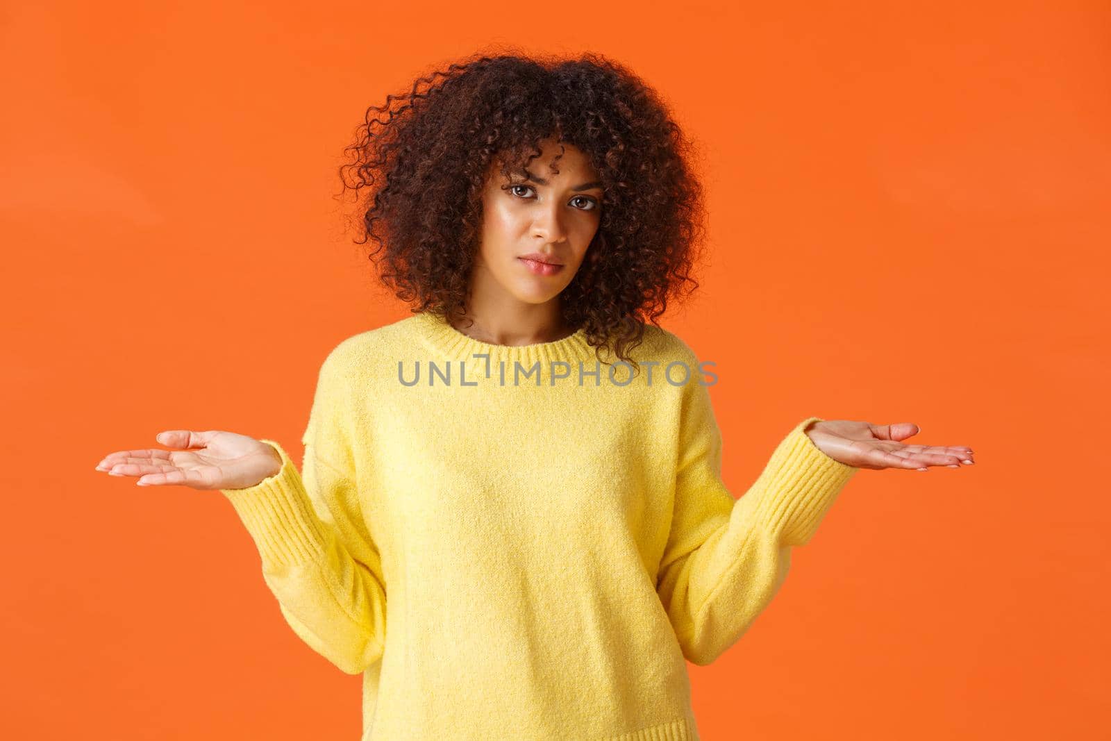 Waist-up shot upset and frustrated, clueless african american curly-haired girl, shrugging with hands spread sideways dismay, dont know, cant understand, feeling perplexed, orange background by Benzoix