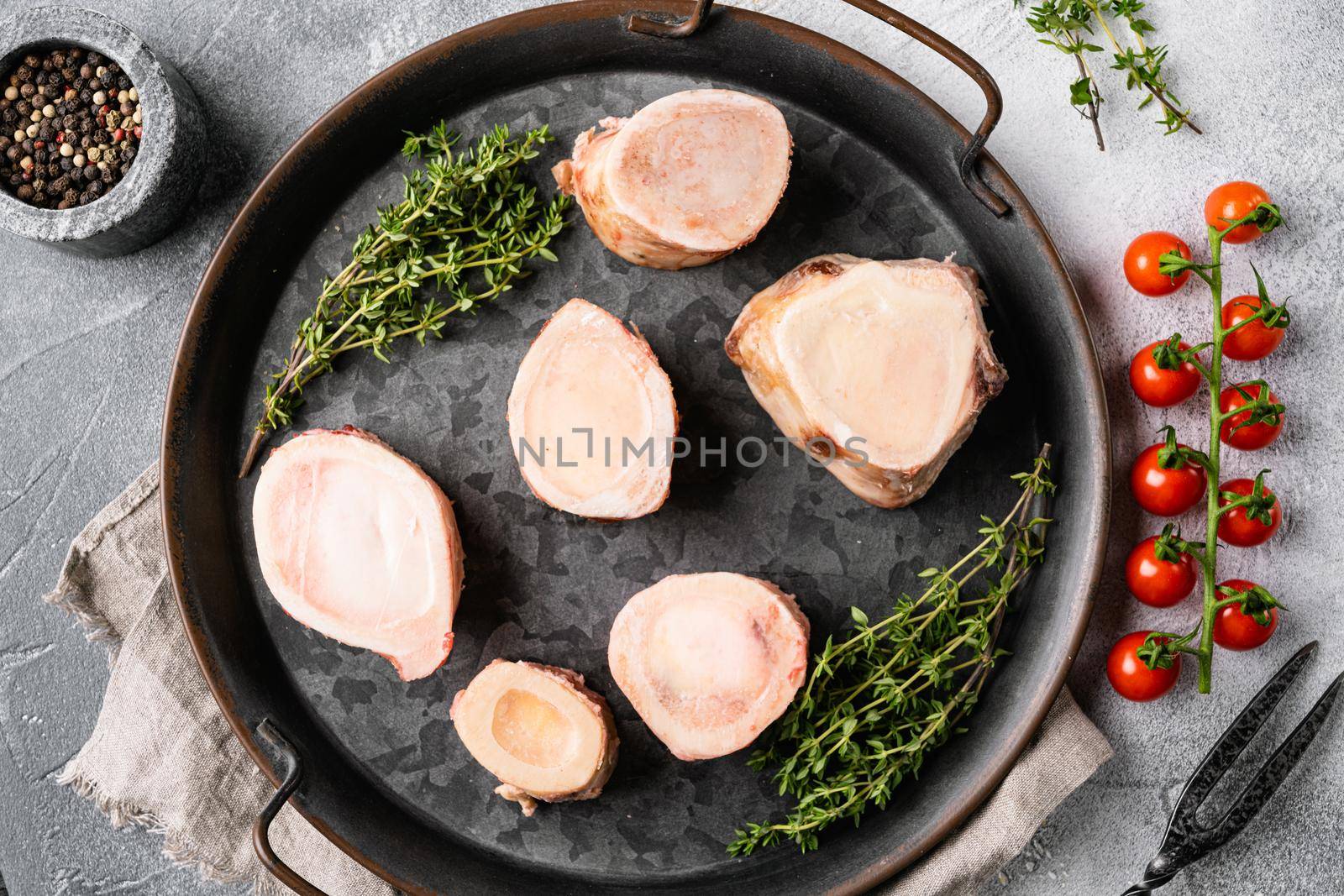 Raw caw bones butcher cut set, on gray stone table background, top view flat lay