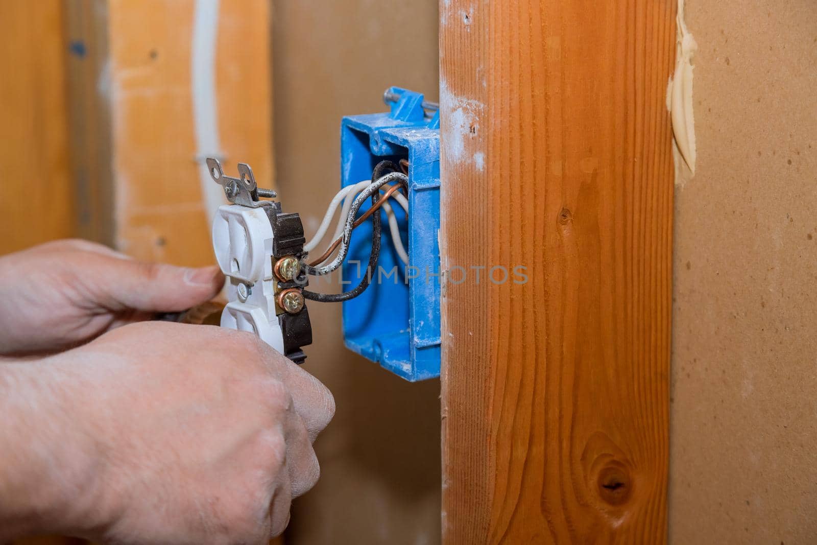 Preparing to remove an electrical outlet of the screws for electrical wires by ungvar