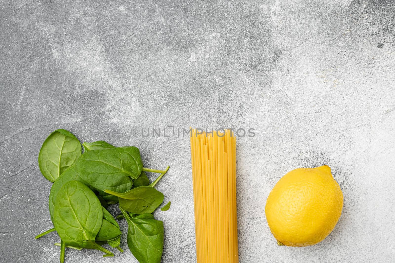 Bunch of spaghetti, raw pasta set, on gray stone table background, top view flat lay, with copy space for text