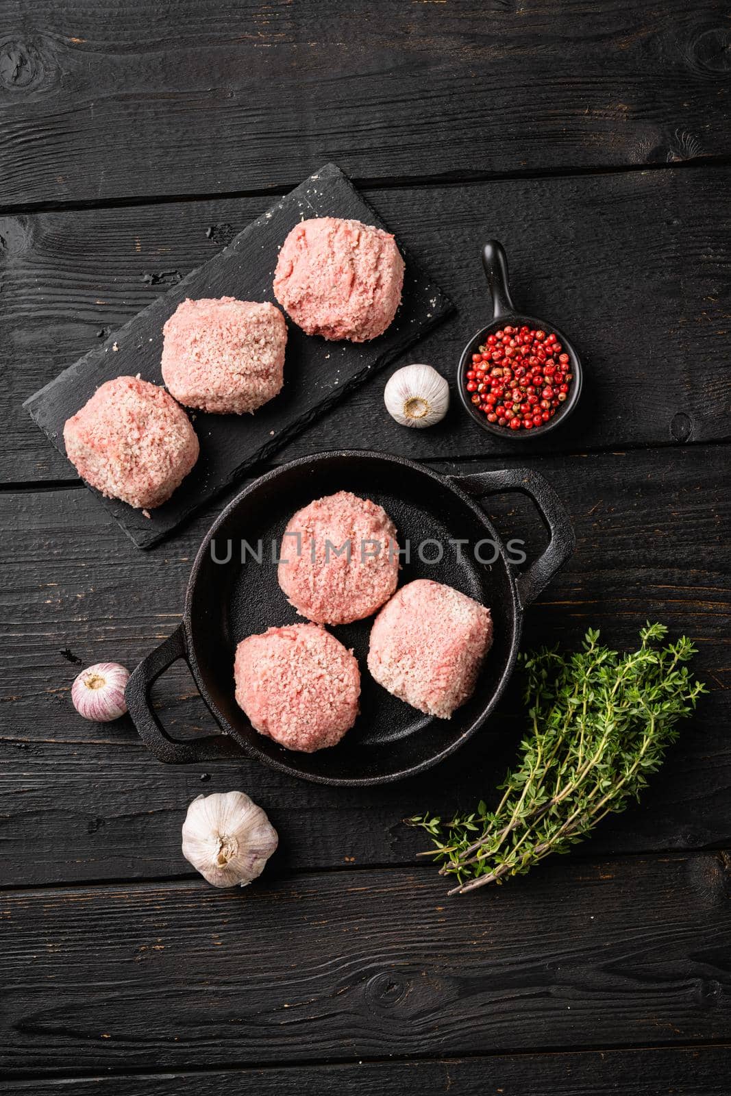 Meatball patties from minced meat set, on black wooden table background, top view flat lay