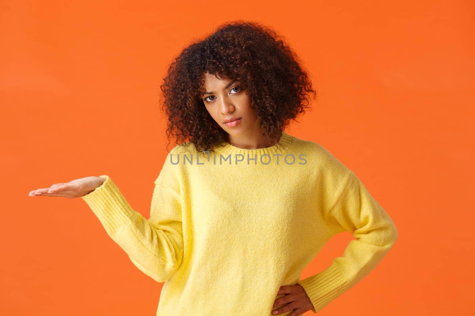 So what, I dont care. Unbothered and careless unimpressed sulking african-american woman with curly hair, raise hand in dismay displeased with bad result, dont give a damn, orange background by Benzoix