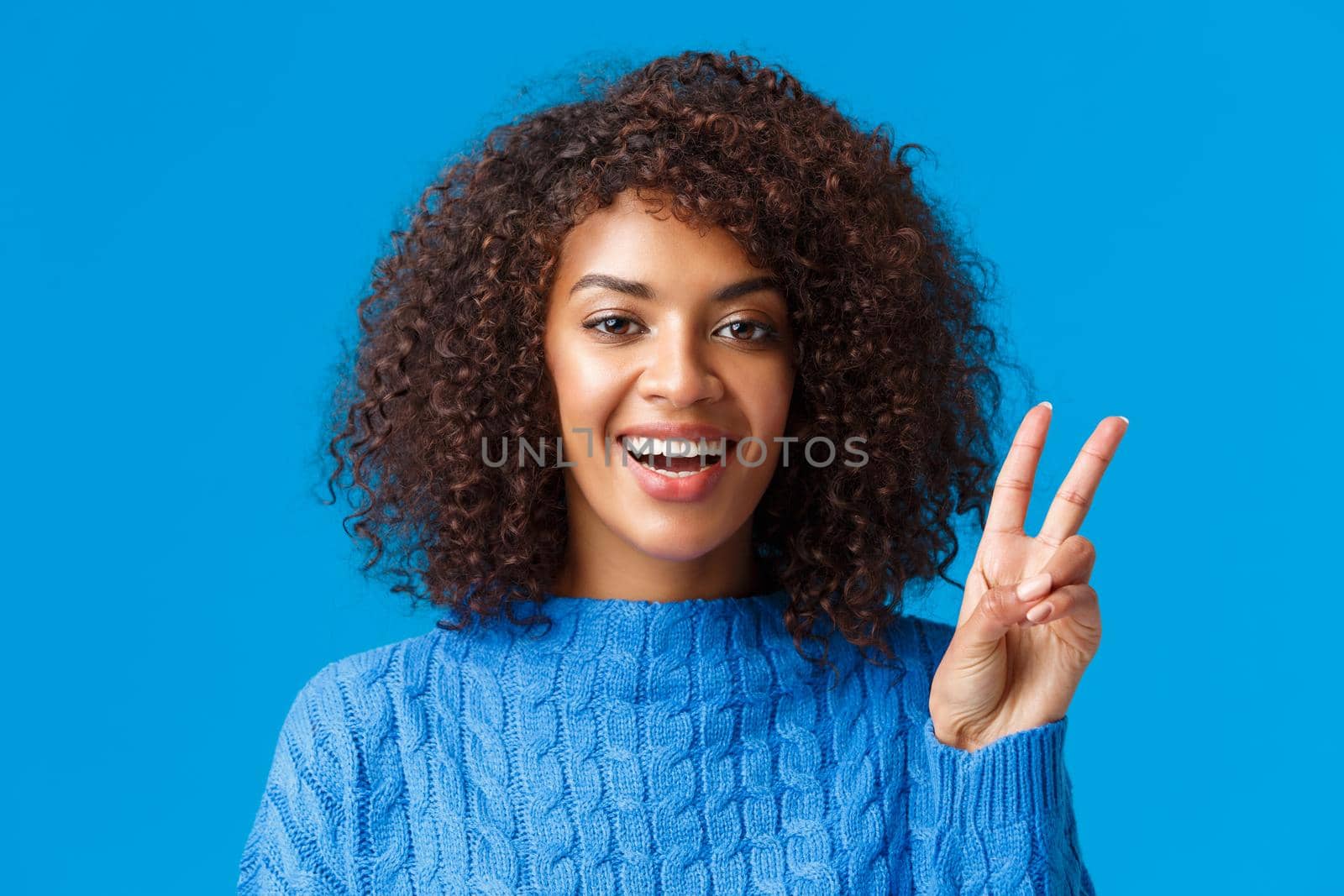 Close-up portrait carefree, happy joyful woman celebrating holidays, wishing everyone good new year, showing peace sign and smiling joyfully, express posivity and joy, wearing sweater by Benzoix