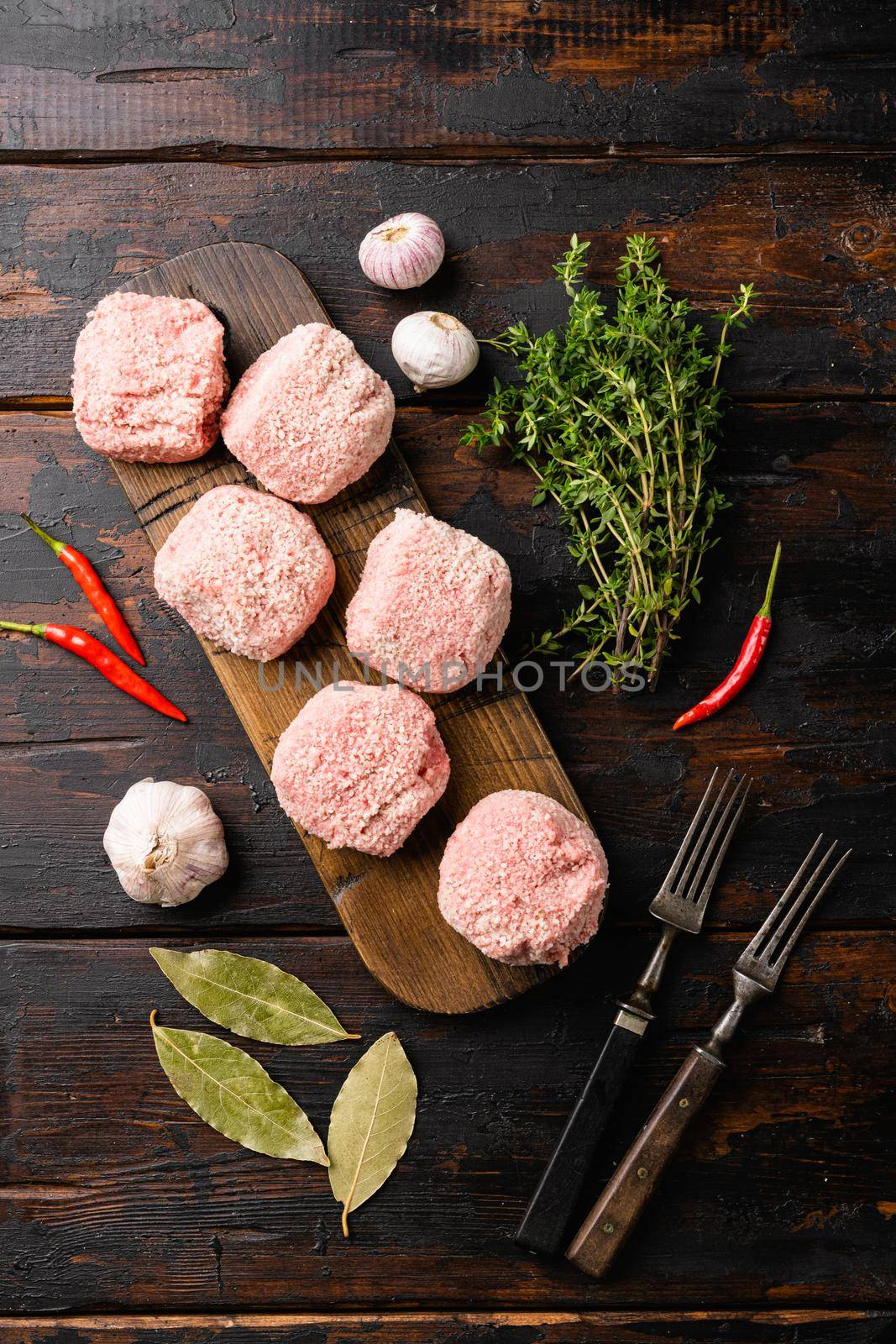 Fresh raw turkey meatballs set, on old dark wooden table background, top view flat lay