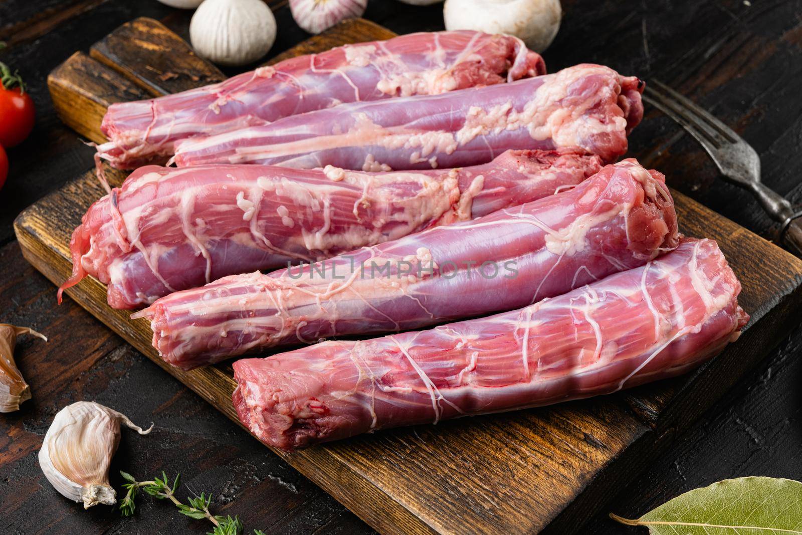 Raw turkey neck without skin set, on old dark wooden table background