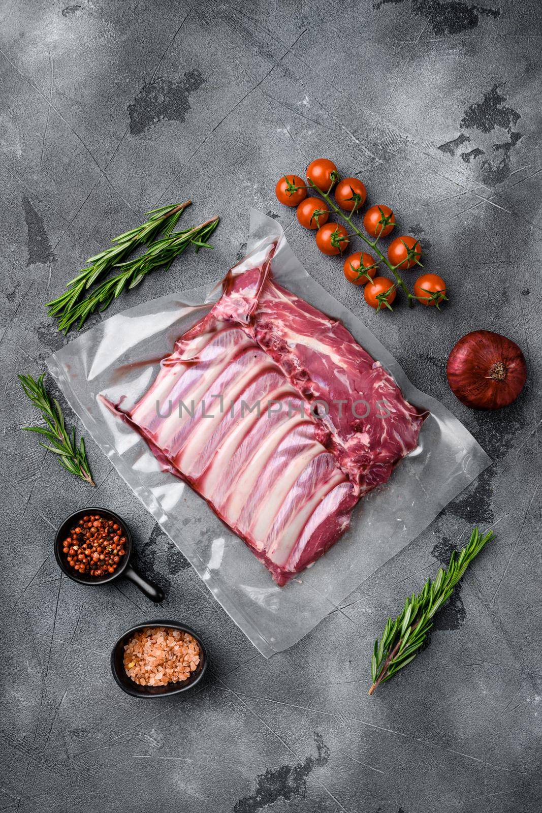 Lamb rib fresh meat Vacuum sealed, on gray stone table background, top view flat lay, with copy space for text by Ilianesolenyi