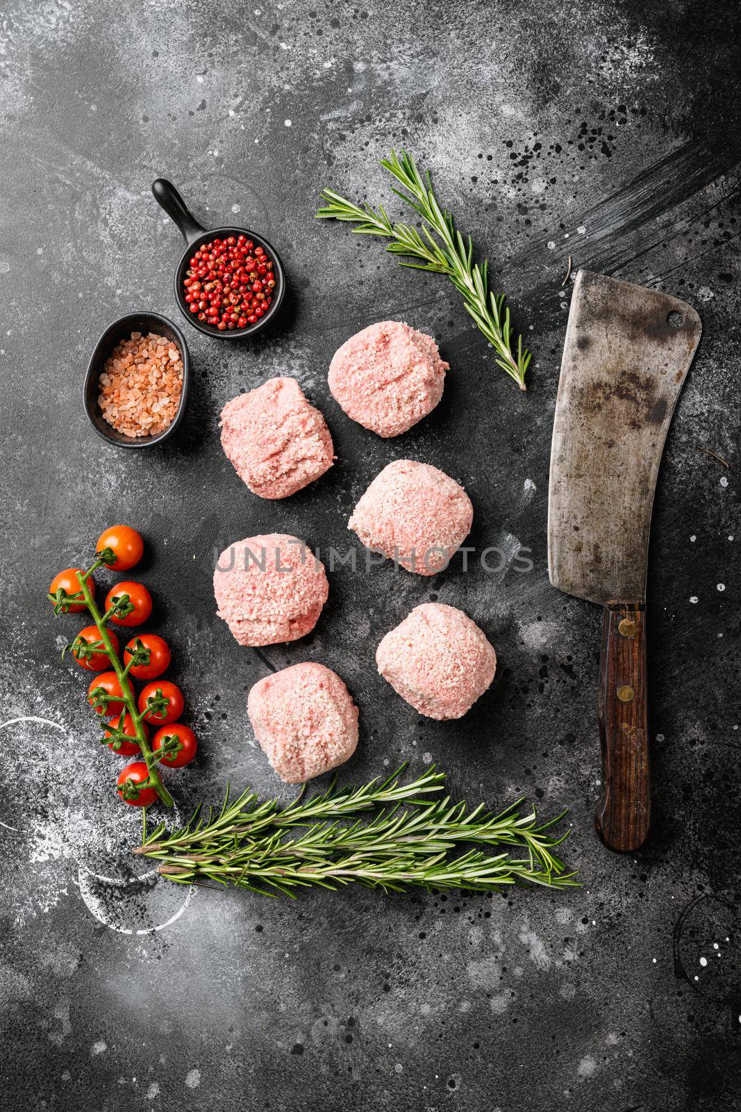 Fresh raw turkey meatballs, on black dark stone table background, top view flat lay by Ilianesolenyi