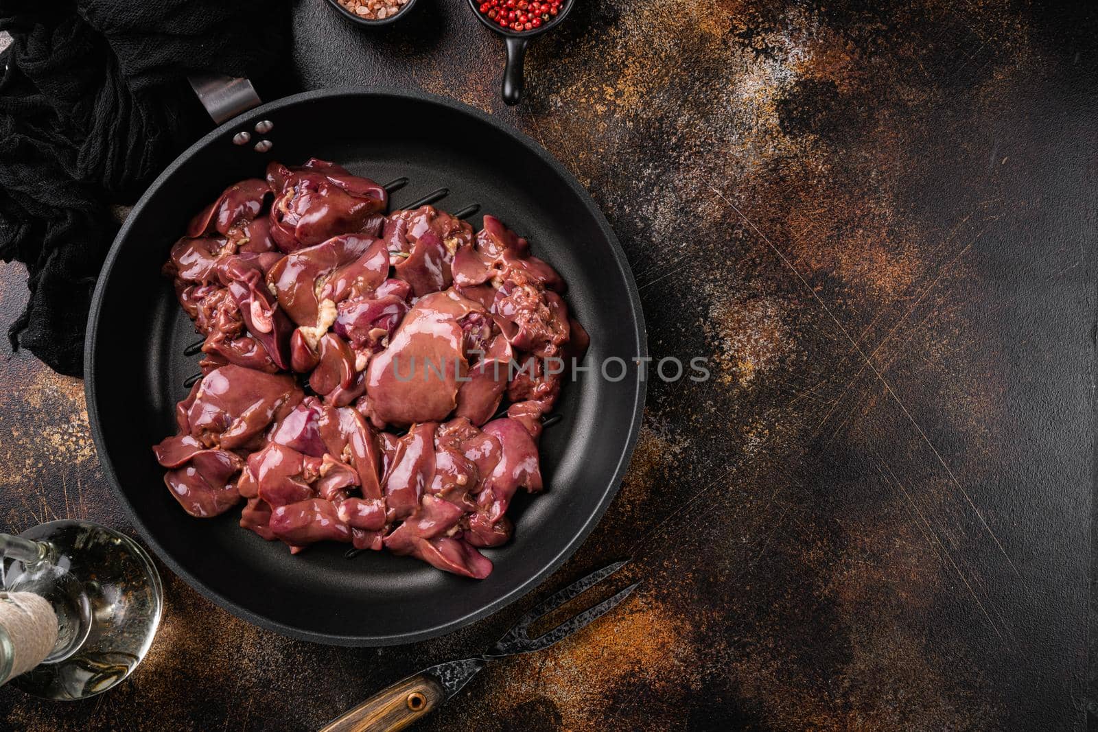 Raw chicken liver set, on old dark rustic table background, top view flat lay, with copy space for text