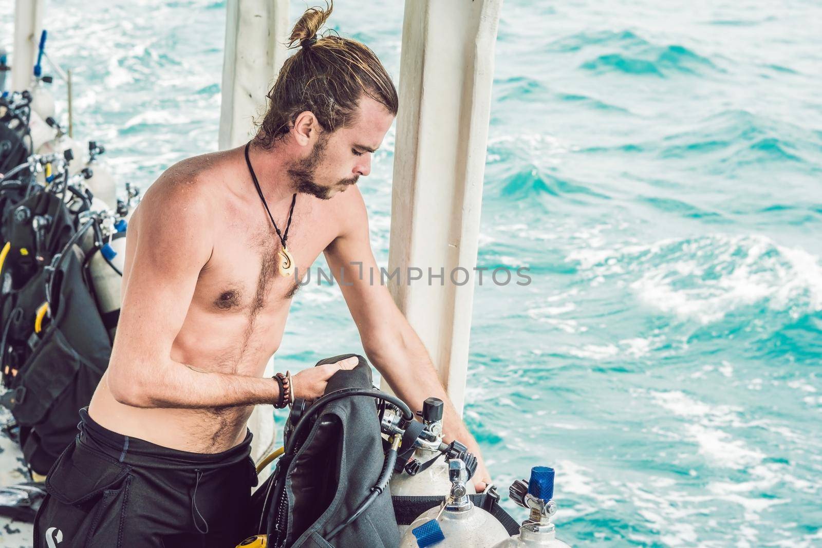 Diver prepares his equipment for diving in the sea.