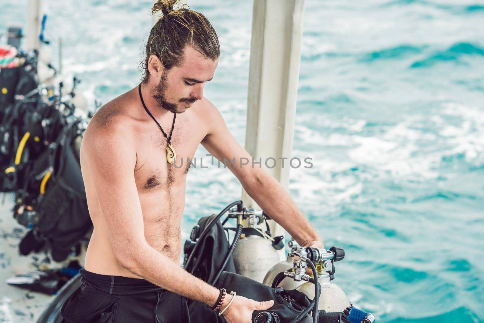 Diver prepares his equipment for diving in the sea.