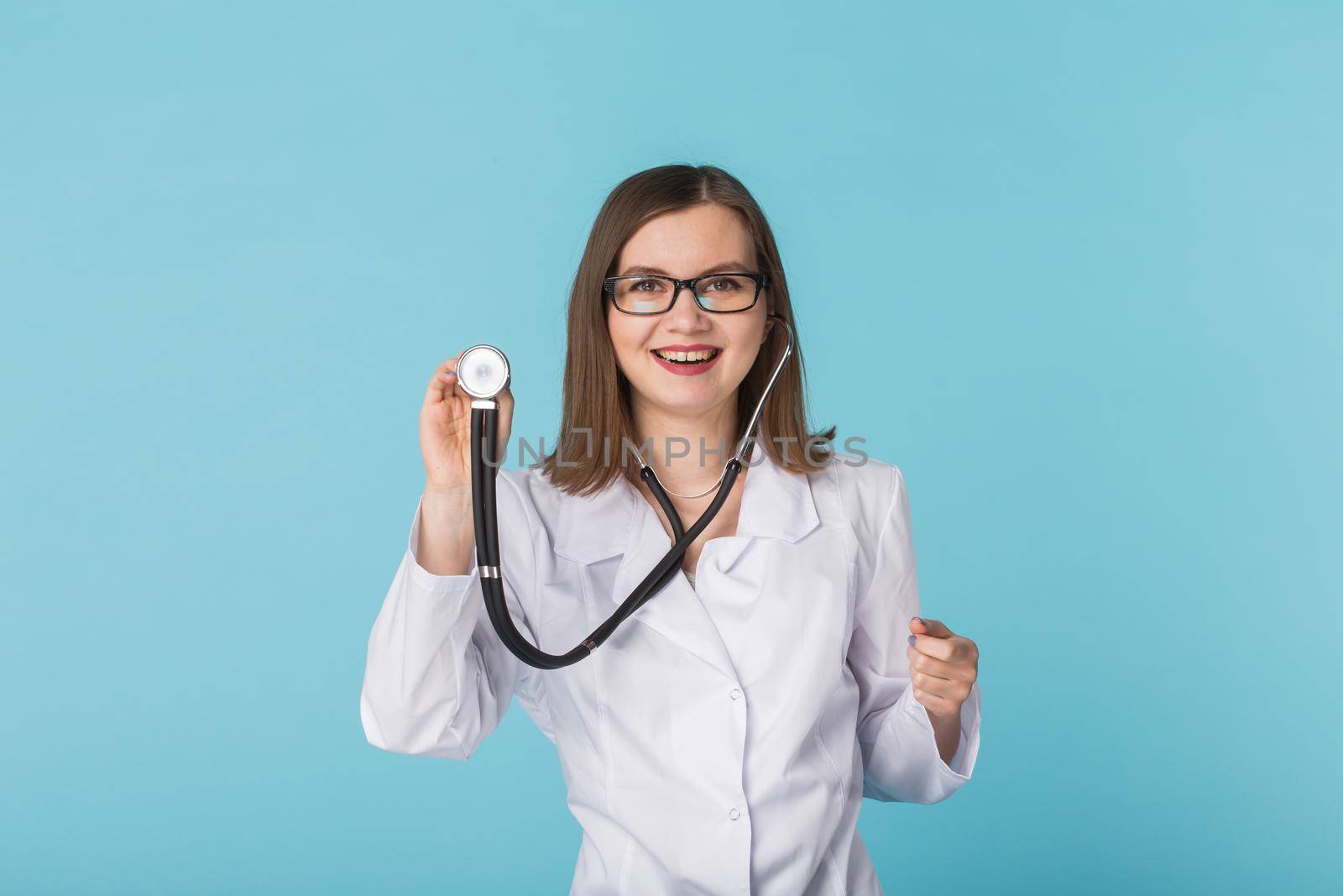 Doctor with stethoscope over blue background by Satura86