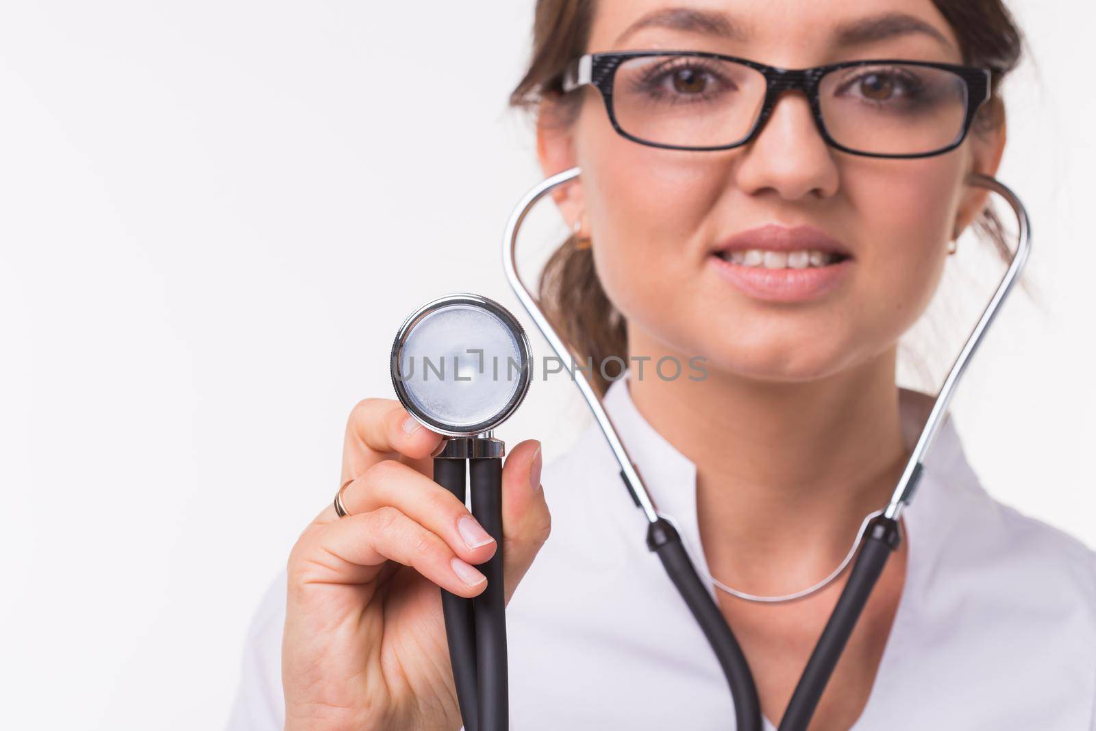 Doctor with phonendoscope, close up over white background.