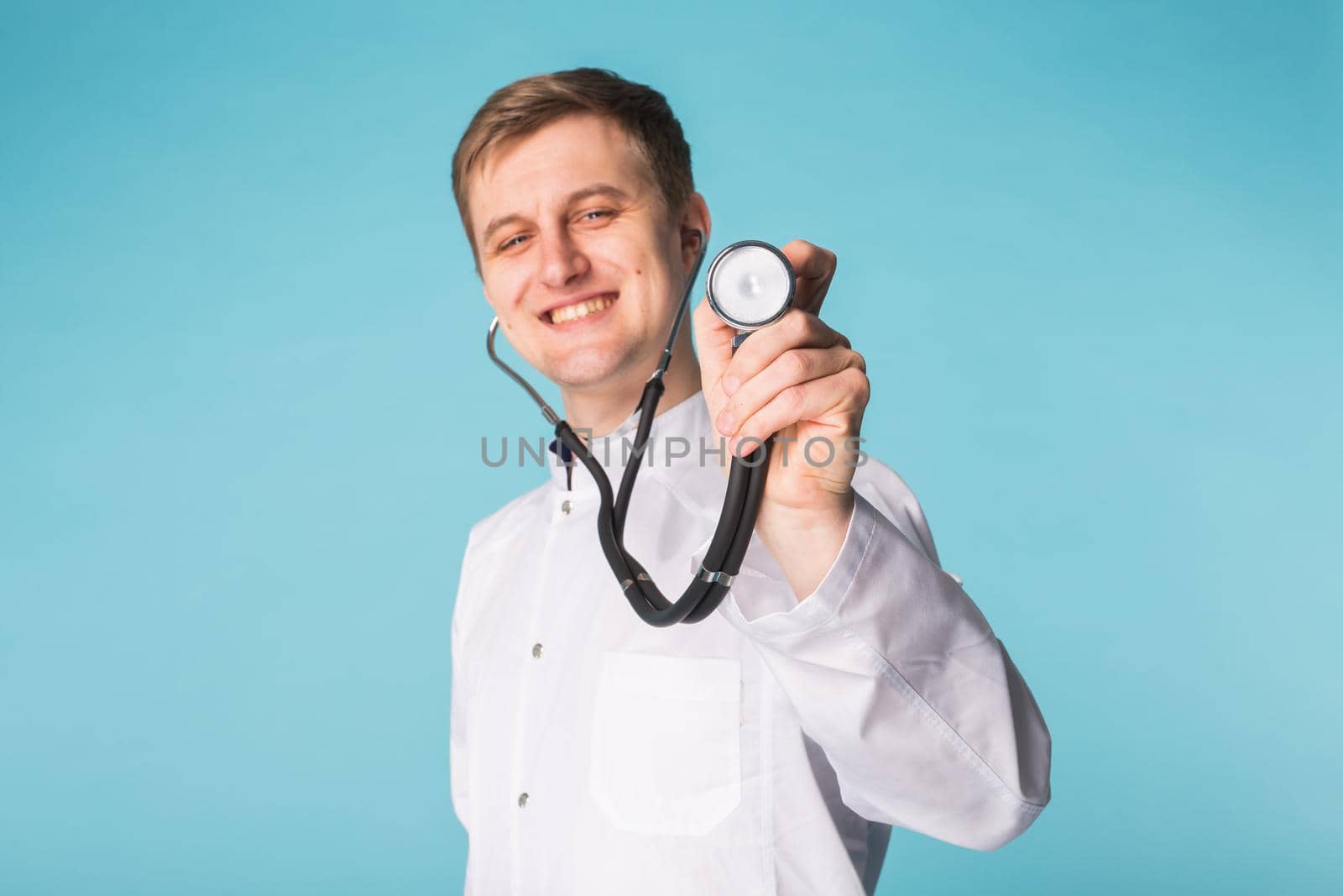 Doctor with stethoscope, close up over blue background by Satura86