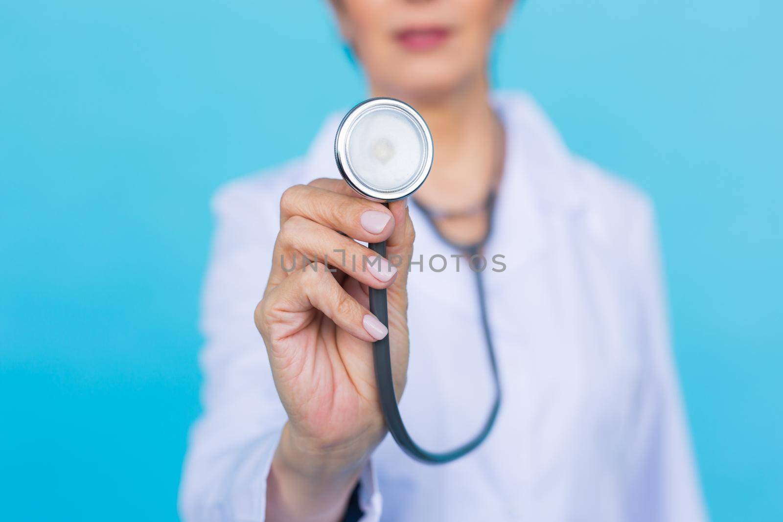 Young female doctor with stethoscope, close up.