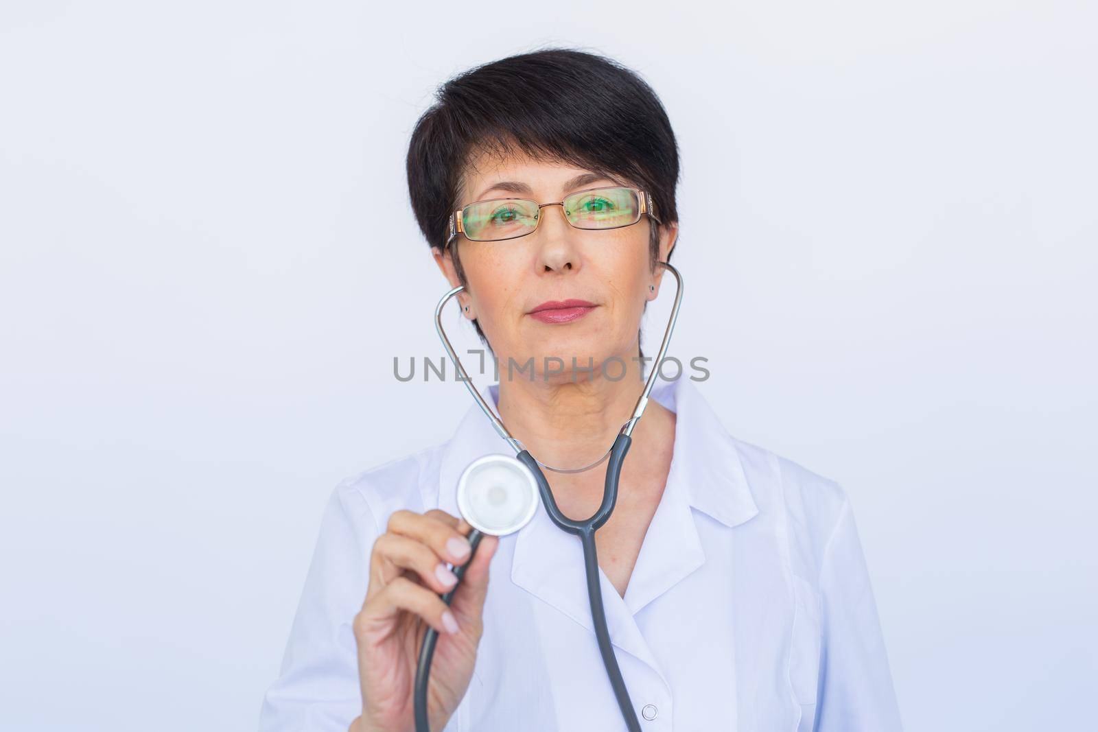 Female doctor with stethoscope, close up over white background by Satura86