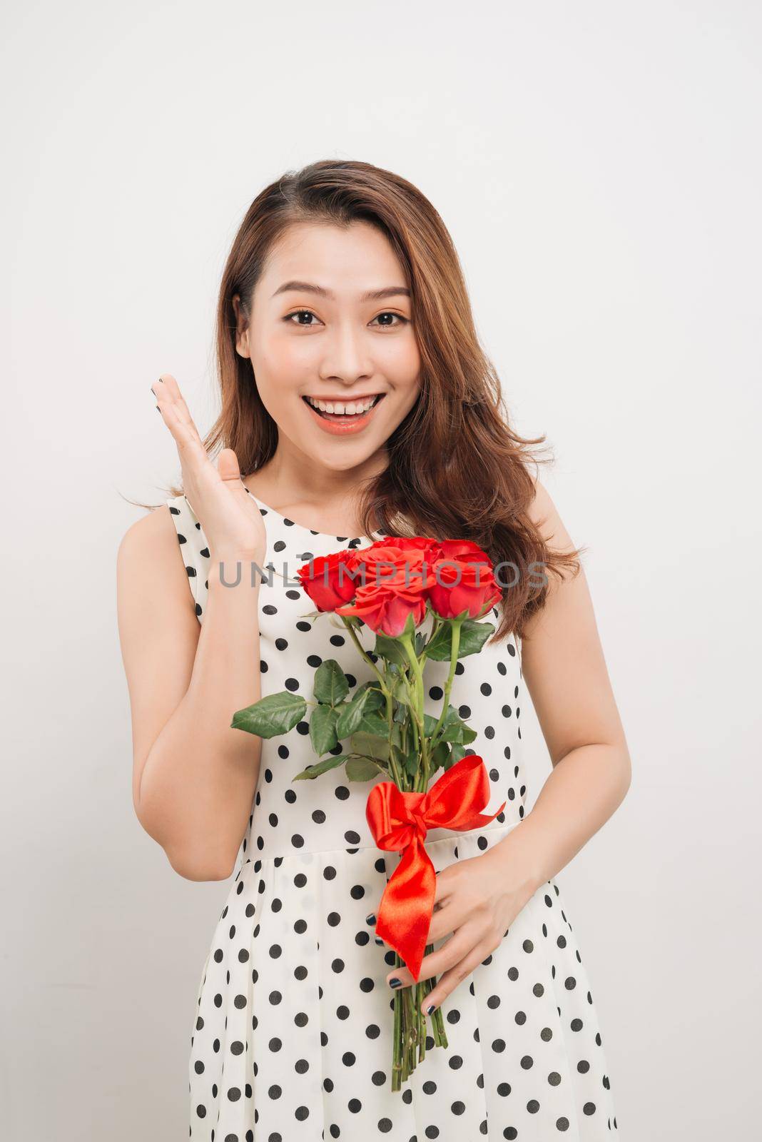 Is it for me. Waist up portrait of joyful young lady receiving red rose by makidotvn