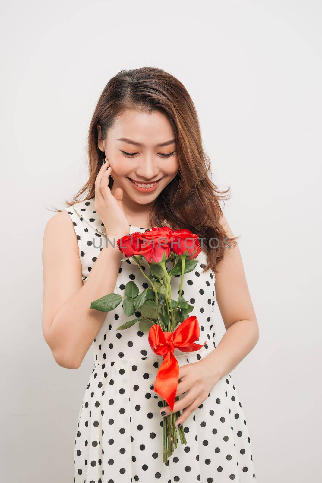 Is it for me. Waist up portrait of joyful young lady receiving red rose by makidotvn