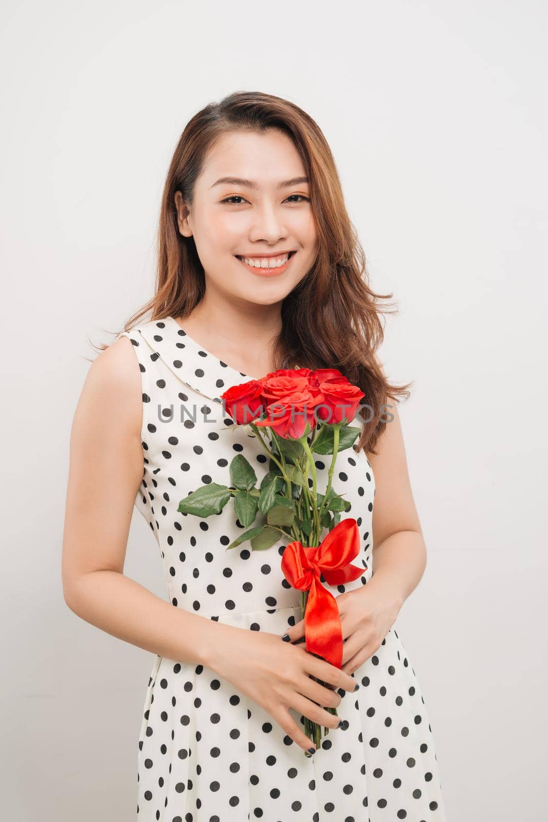 Is it for me. Waist up portrait of joyful young lady receiving red rose by makidotvn