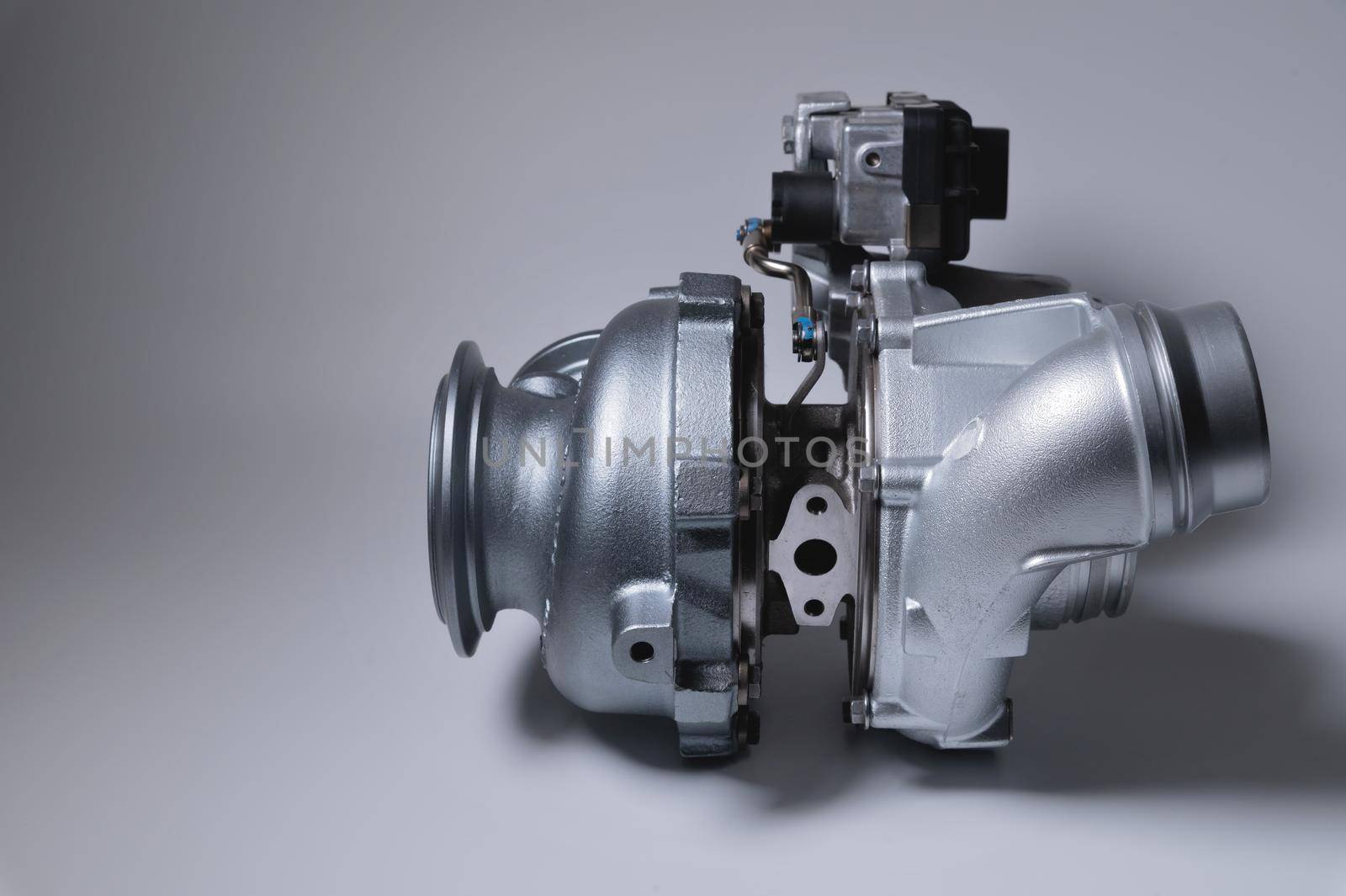 New metal turbocharger. Exhaust gas blower. Parts background.