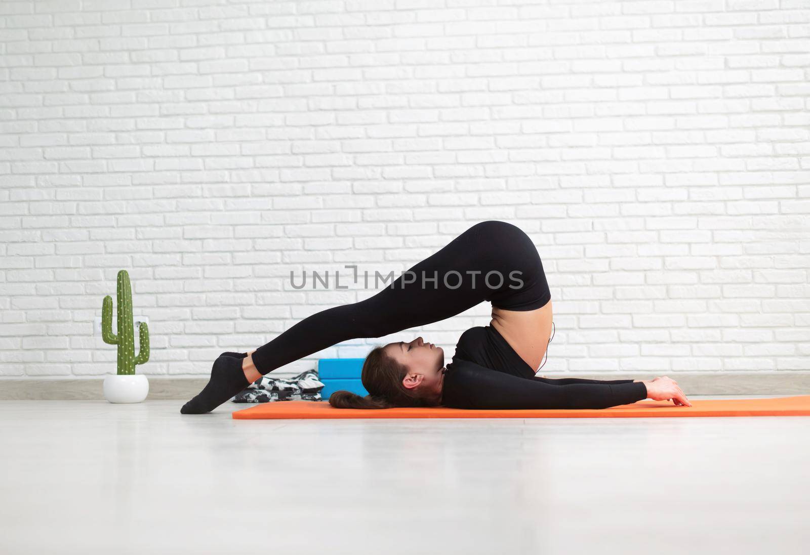 girl conducts a home workout stretching to strengthen her back