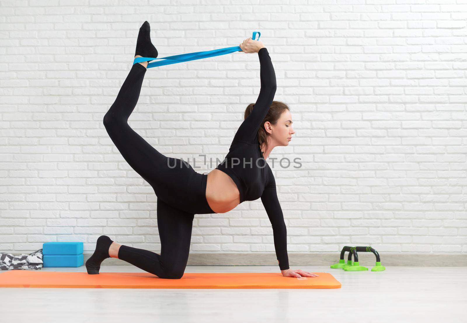 girl conducts a home workout stretching to strengthen her back