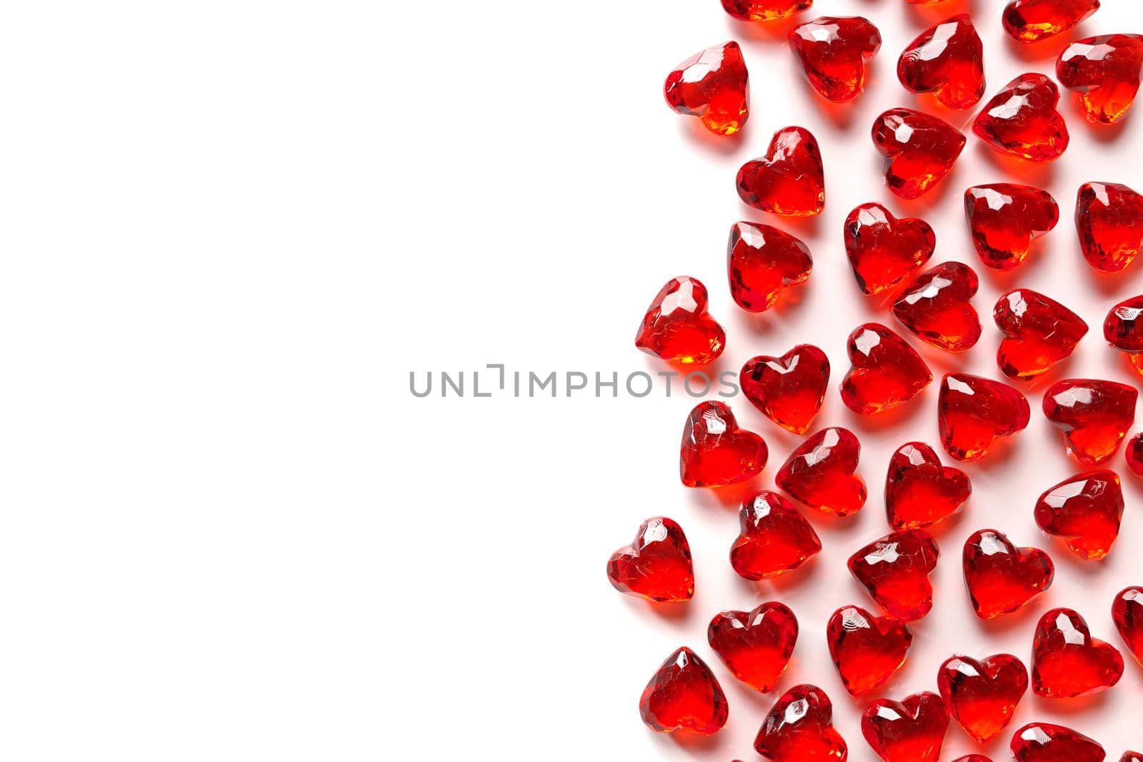 Full Frame Image of Sparkling Red Gemstone Hearts on a White Studio Background by markvandam
