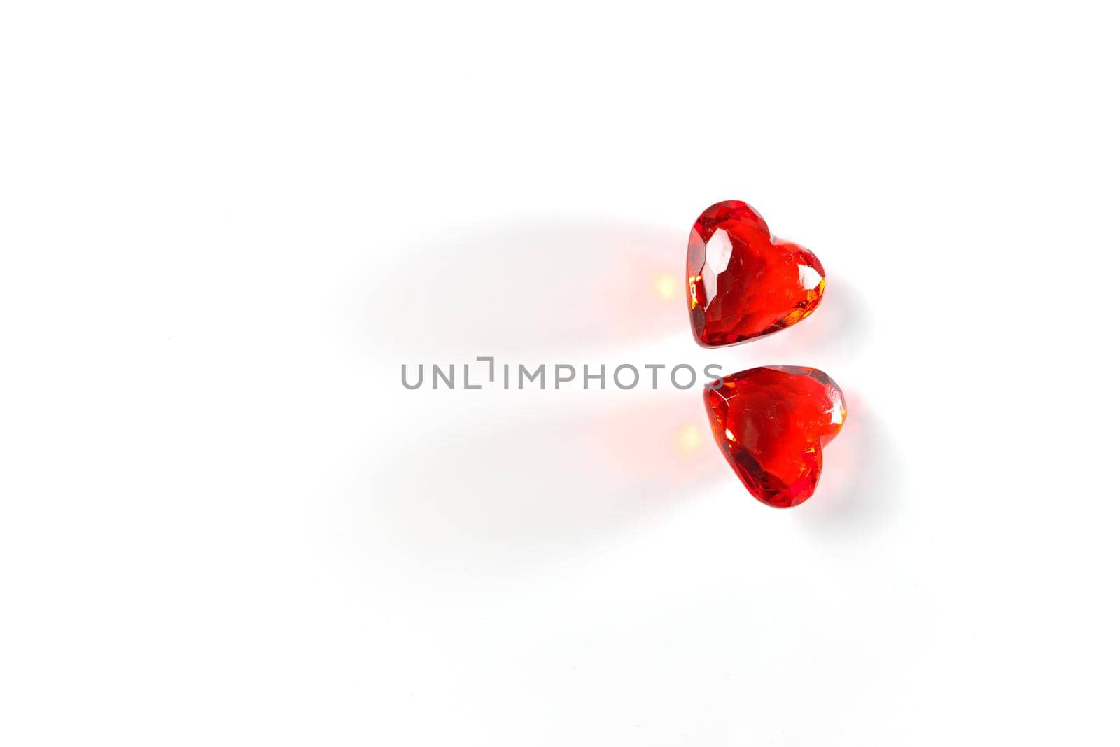Directly Above Studio mage of Two Sparkling Red Gemstone Hearts, side-by-side, on a White Studio Background. This image has plenty of White Copy Space.