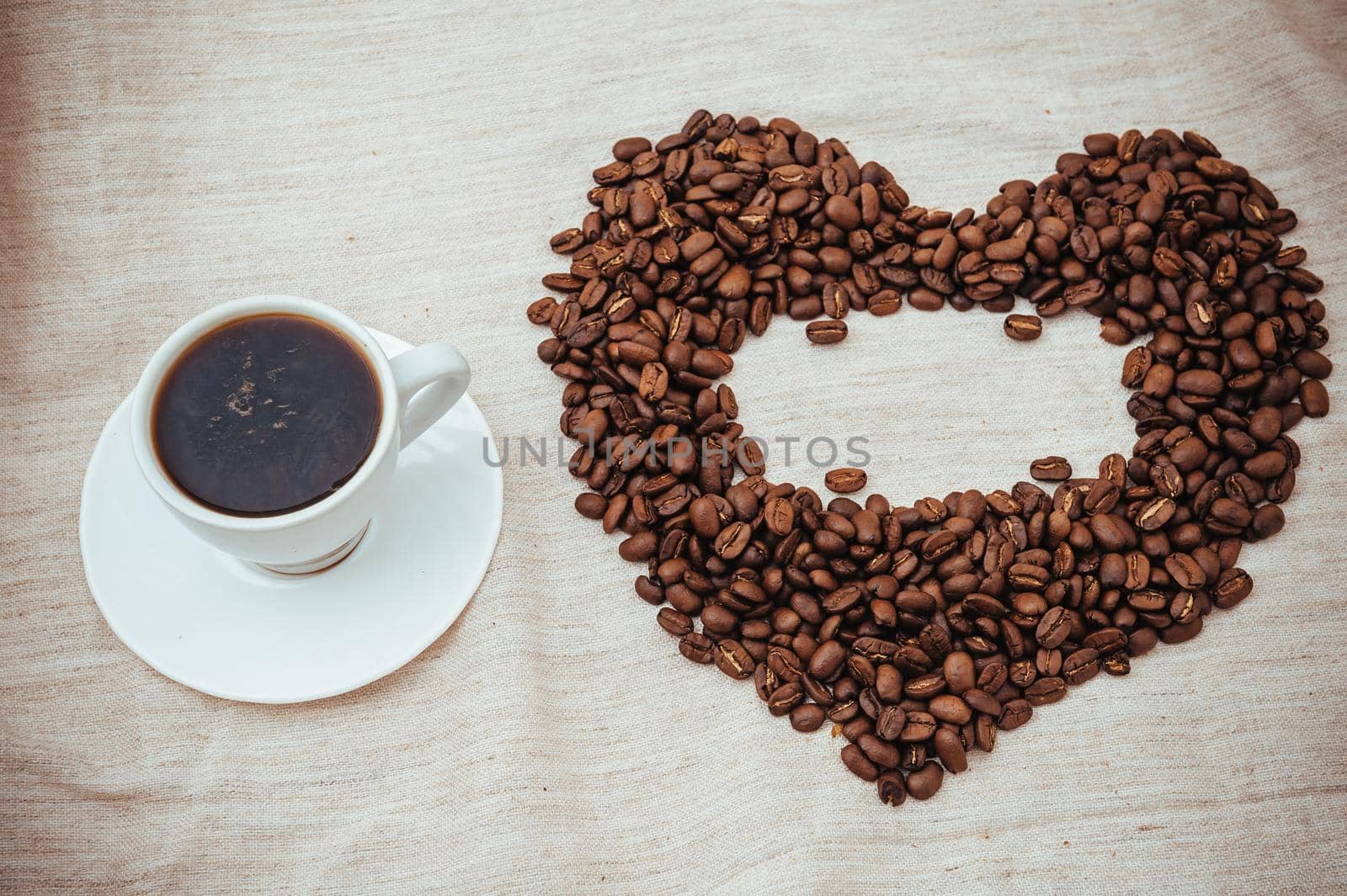 Cup of Coffe. Coffee beans in shape of heart. coffee beans isolated on white background. roasted coffee beans, can be used as a background.