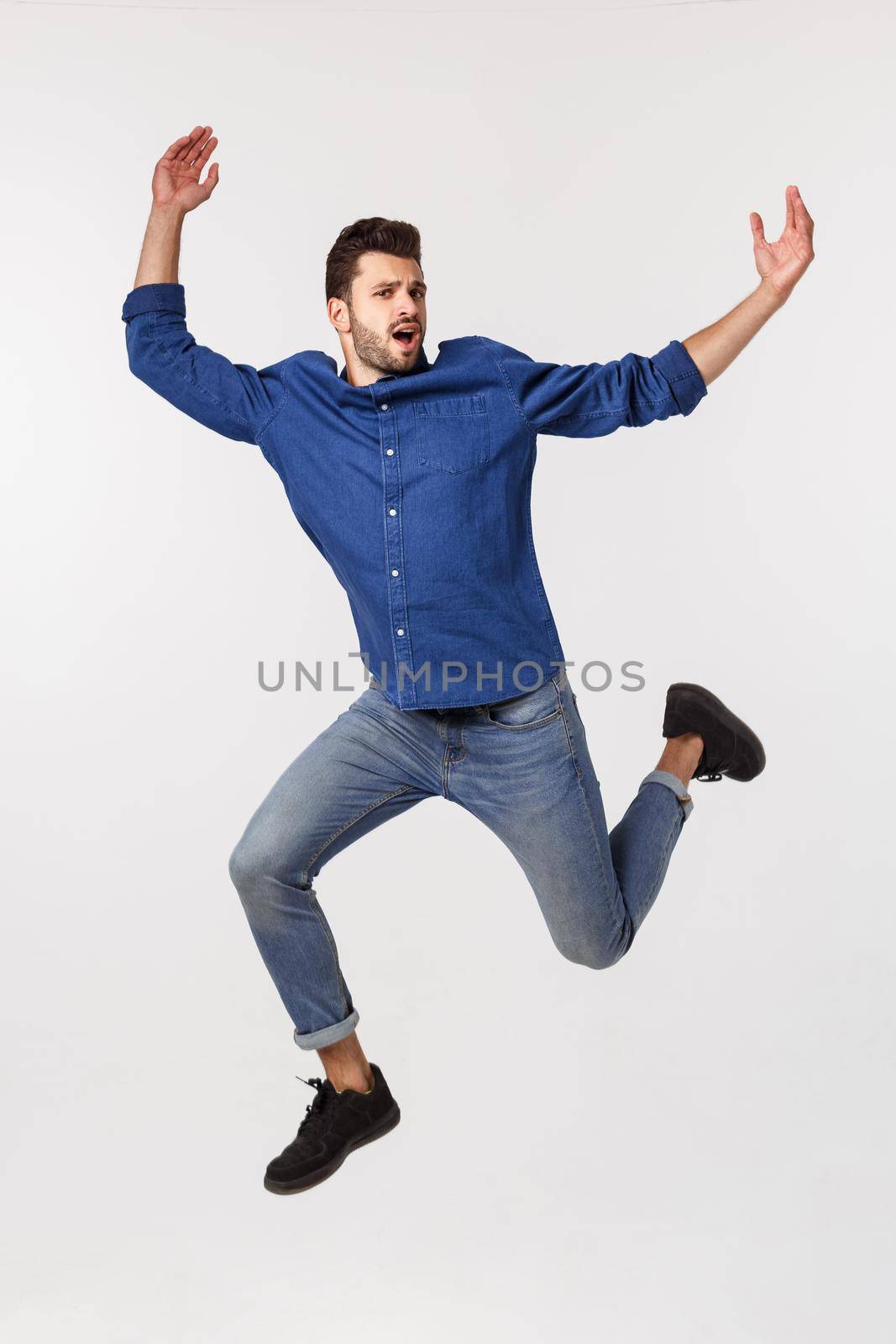An attractive athletic businessman jumping up against white background by Benzoix