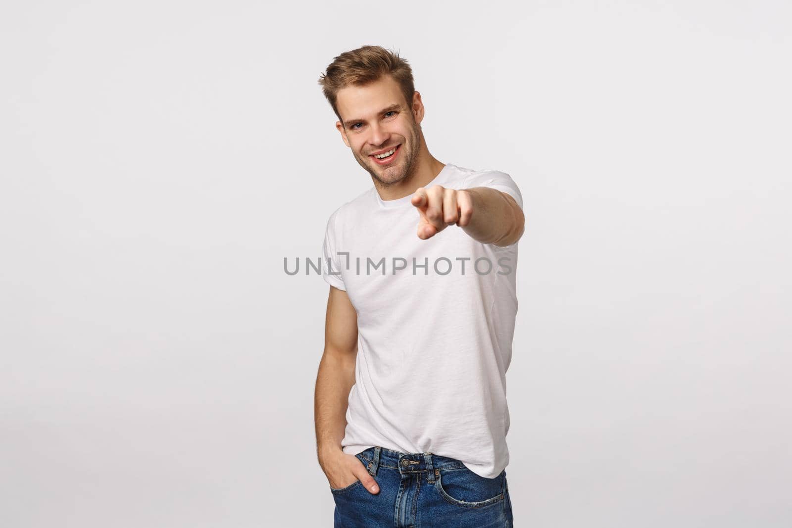 We need you, come here. Attractive and assertive, confident sassy blond guy looking for employees, pointing finger at camera and smiling pleased, found excellent person for company vacancy.