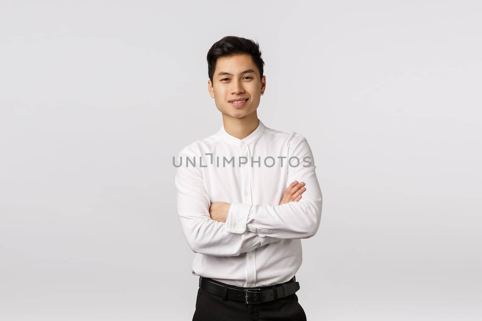 Cheerful, lucky and successful good-looking asian young male entrepreneur, finished business school and ready handle any task work, cross arms over chest, smiling pleased, white background.