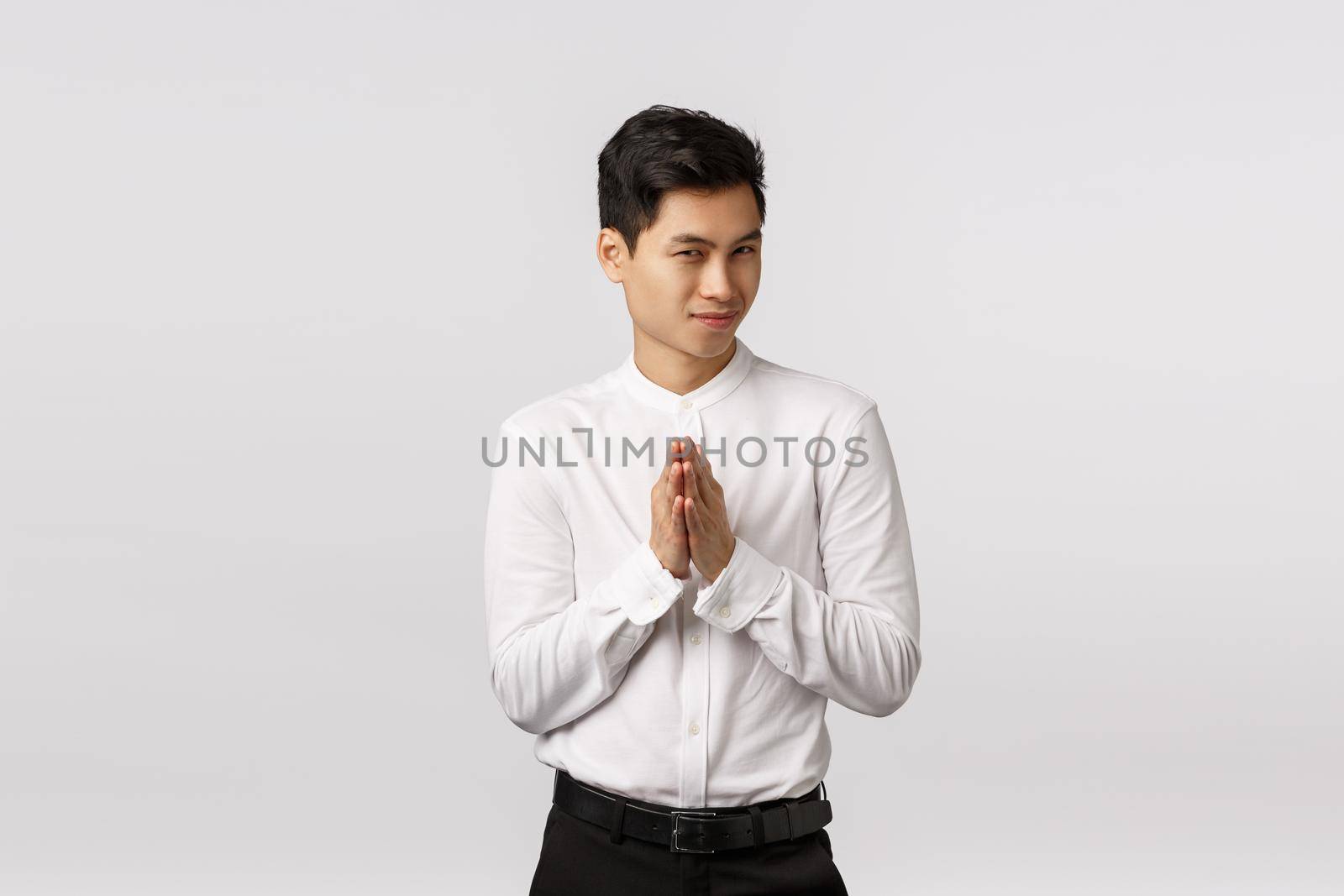 Mysterious and devious young good-looking asian businessman in white shirt, pants, rub hands and squinting sly, have secret evil plan, relish good deal, make money, standing white background by Benzoix