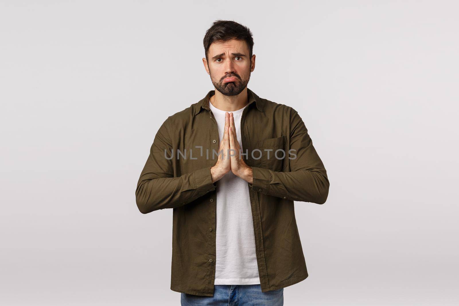 Upset, miserable and gloomy cute bearded guy in casual outfit, begging for help need something, press palms together asking offer, praying, supplicating, ask apology, white background by Benzoix