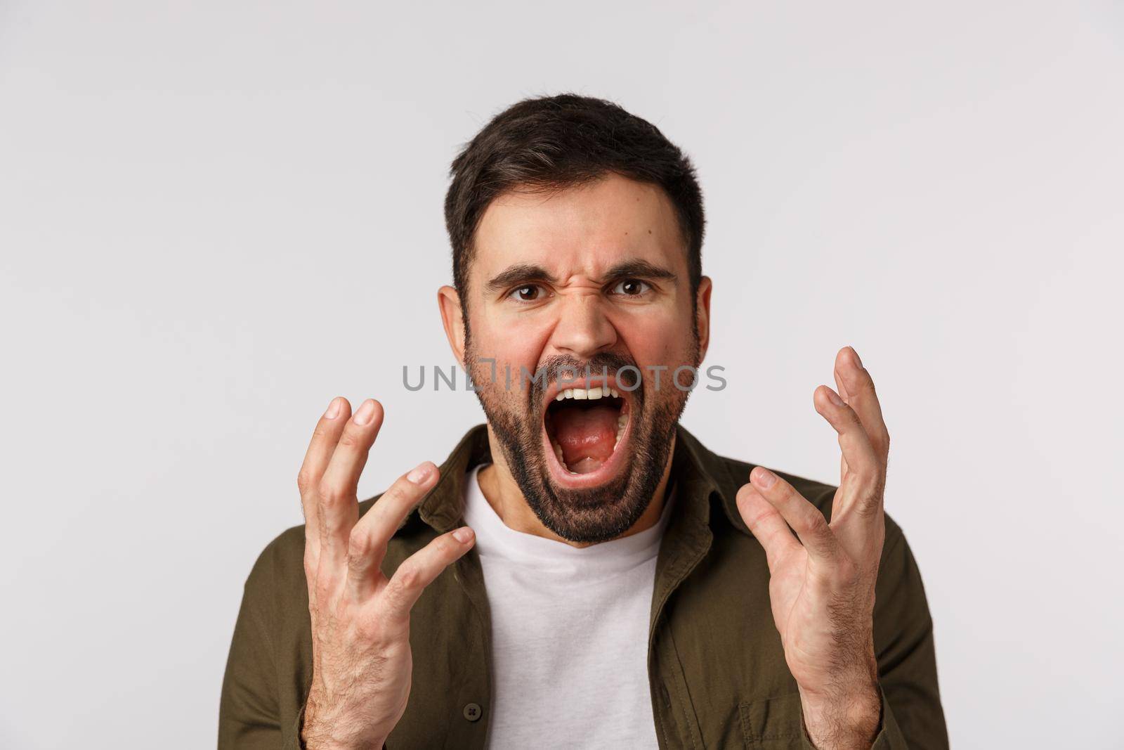 Man losing temper feeling aggression and depression. Distressed and bothered bearded male fed up, tired of arguing shouting, shaking hands aggressive and cursing someone, look angry, white background by Benzoix