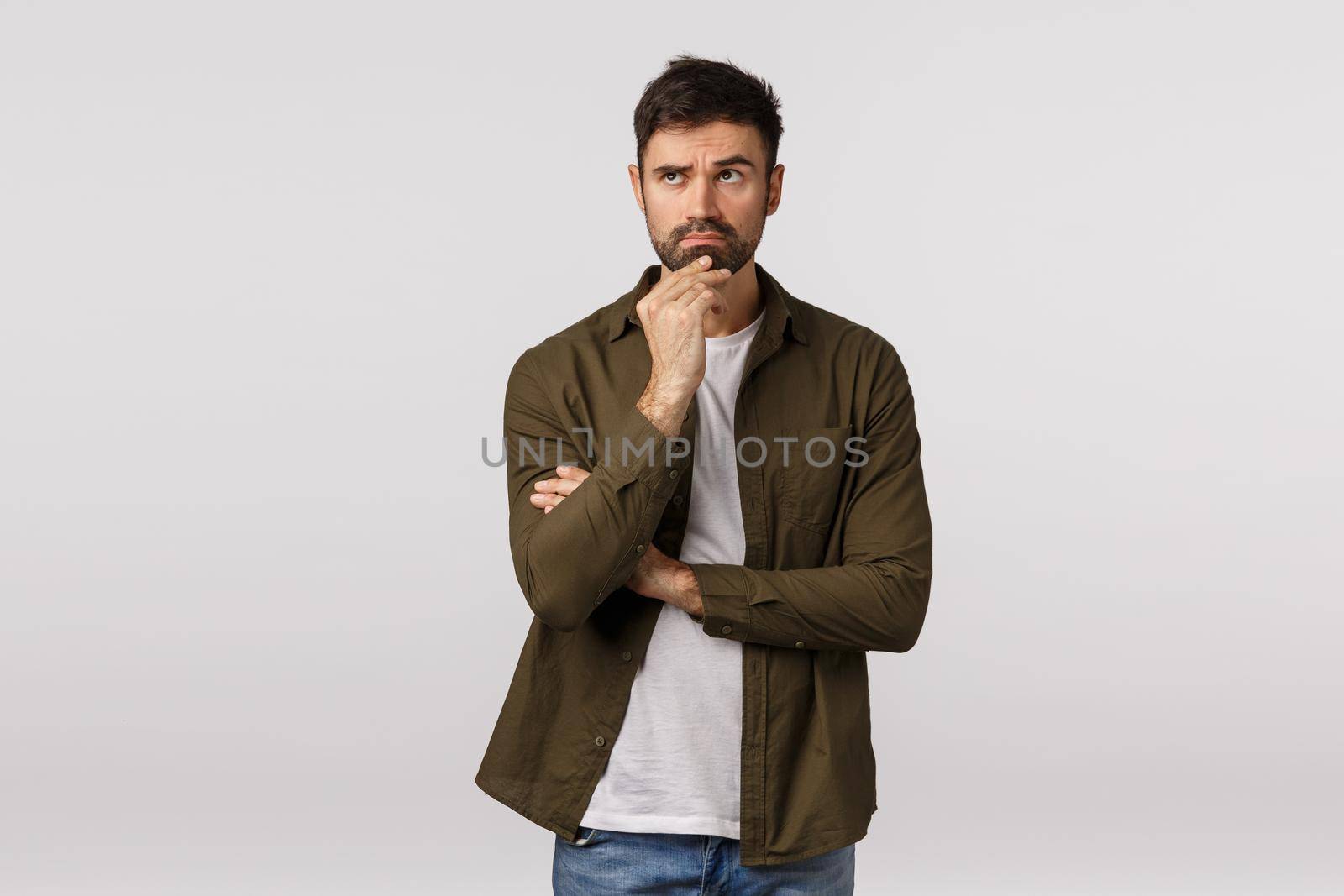 Man thinking, taking serious decision, making hard choice, Serious-looking bossy caucasian bearded male in coat, touching chin, look focused upper left corner, making plan, search solution.