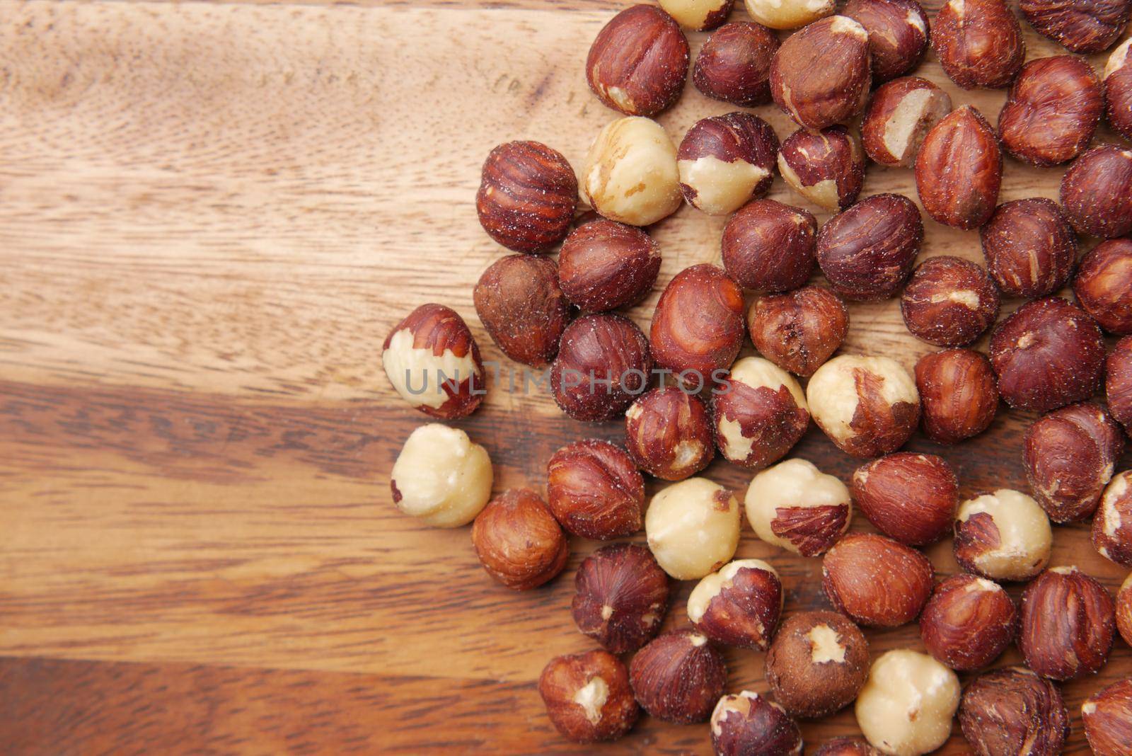 hazelnuts in a container on black background