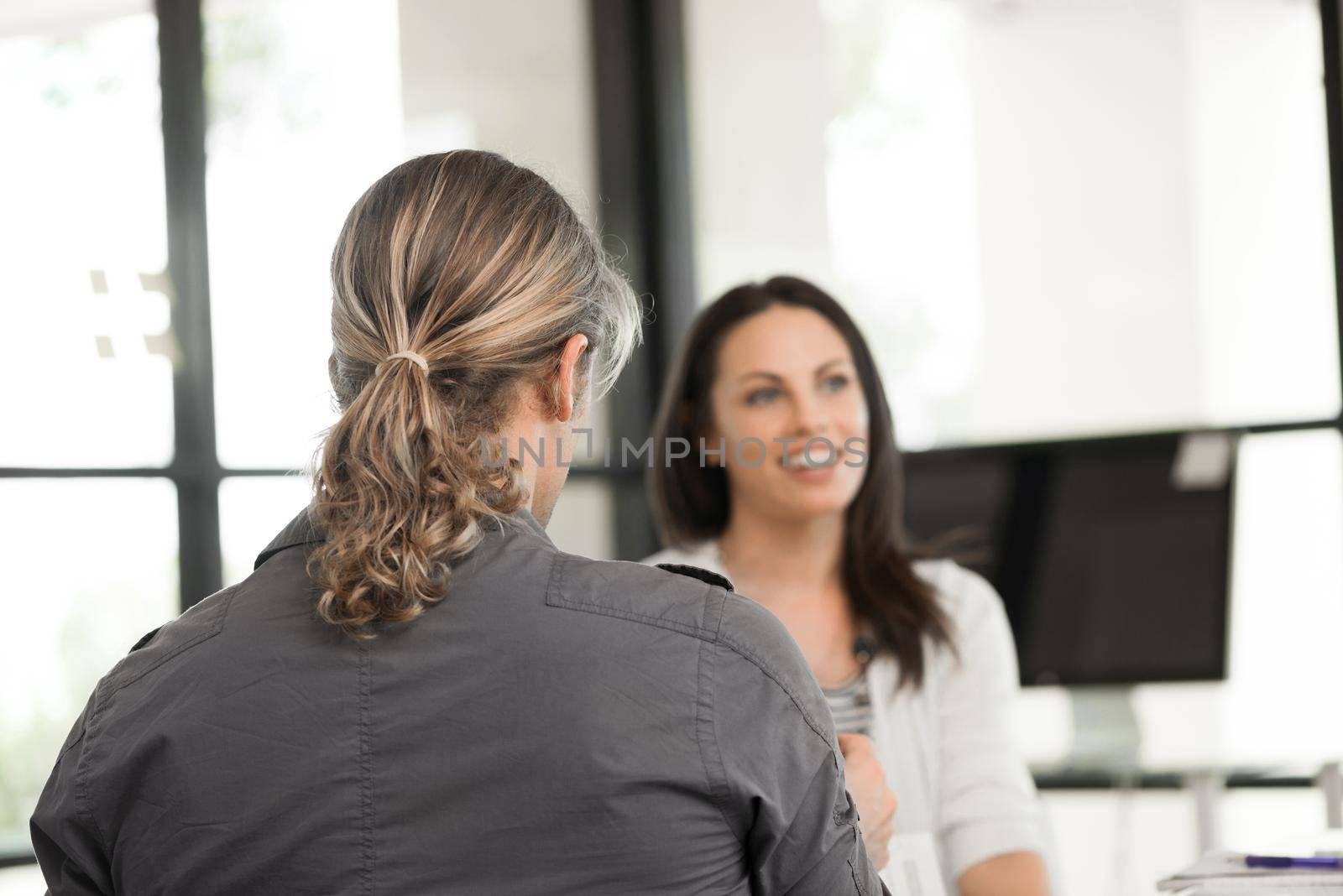 Young coworkers in office working together and discussing points