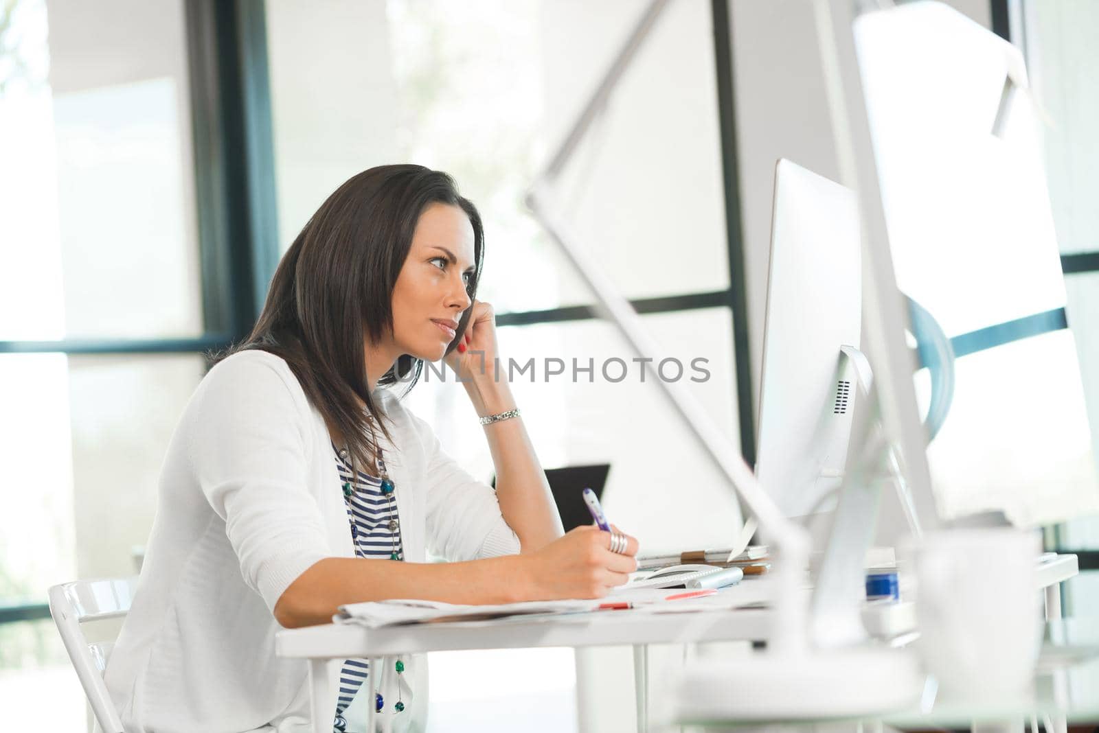 Attractive brunette woman at office desk work on computer