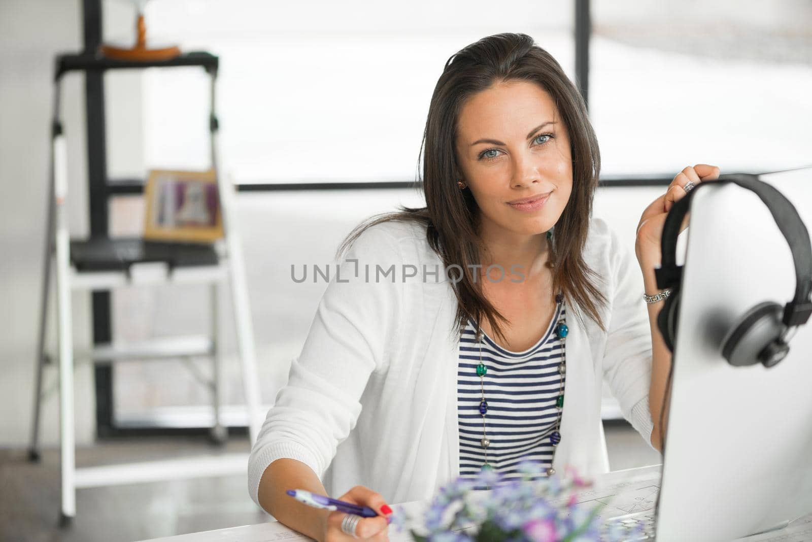 Attractive brunette woman at office desk work on computer