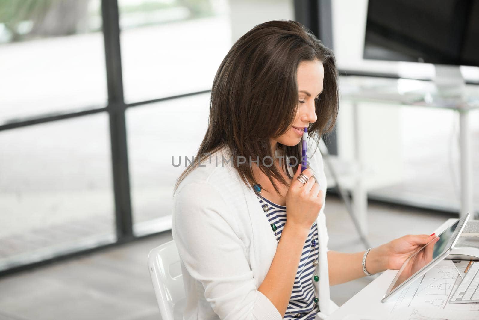 Young attractive brunette working with tablet pc