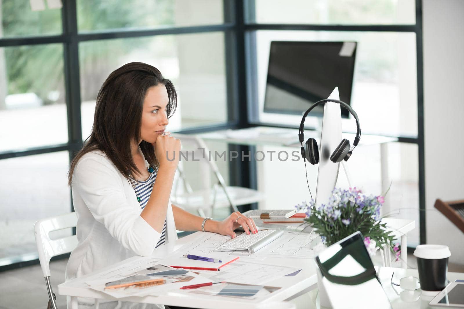 Attractive brunette woman at office desk work on computer