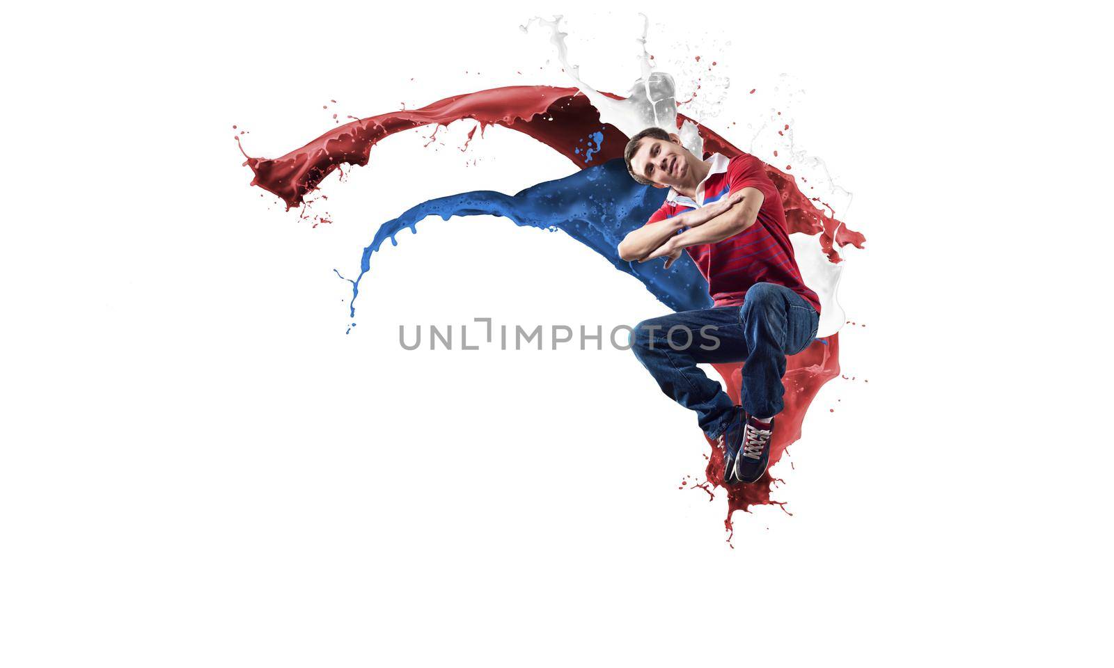 Young male dancer in jump on white background with colorful paint plashes