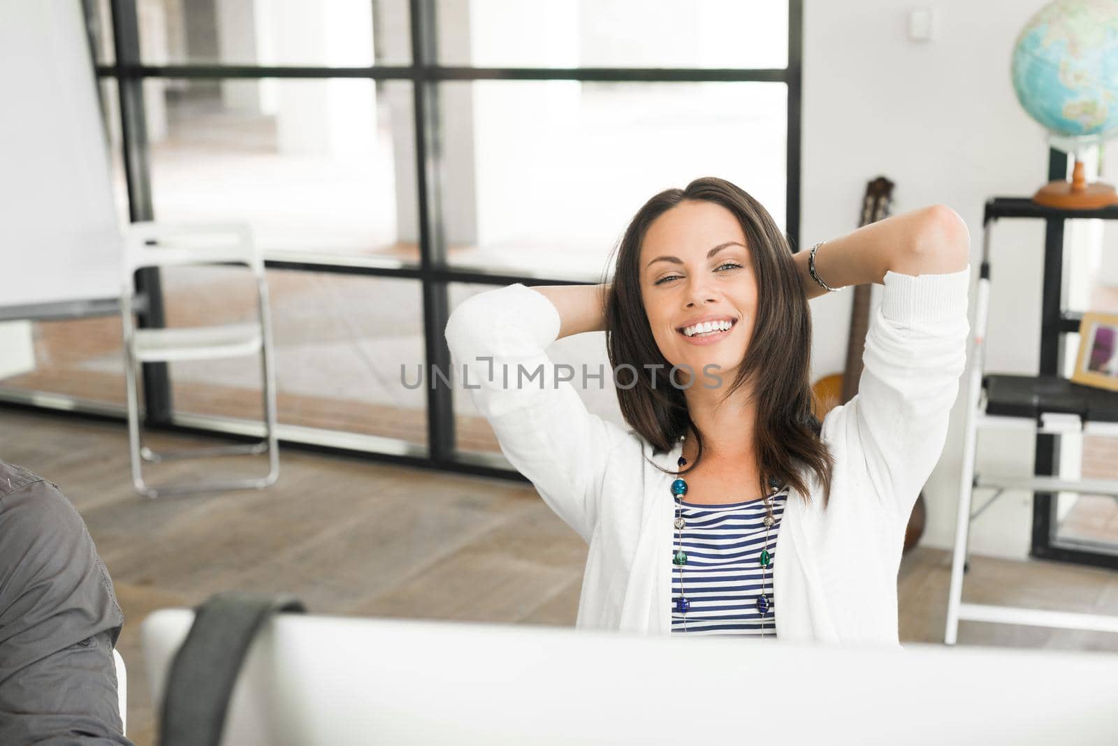 Portrait of pretty brunette woman at desk in office