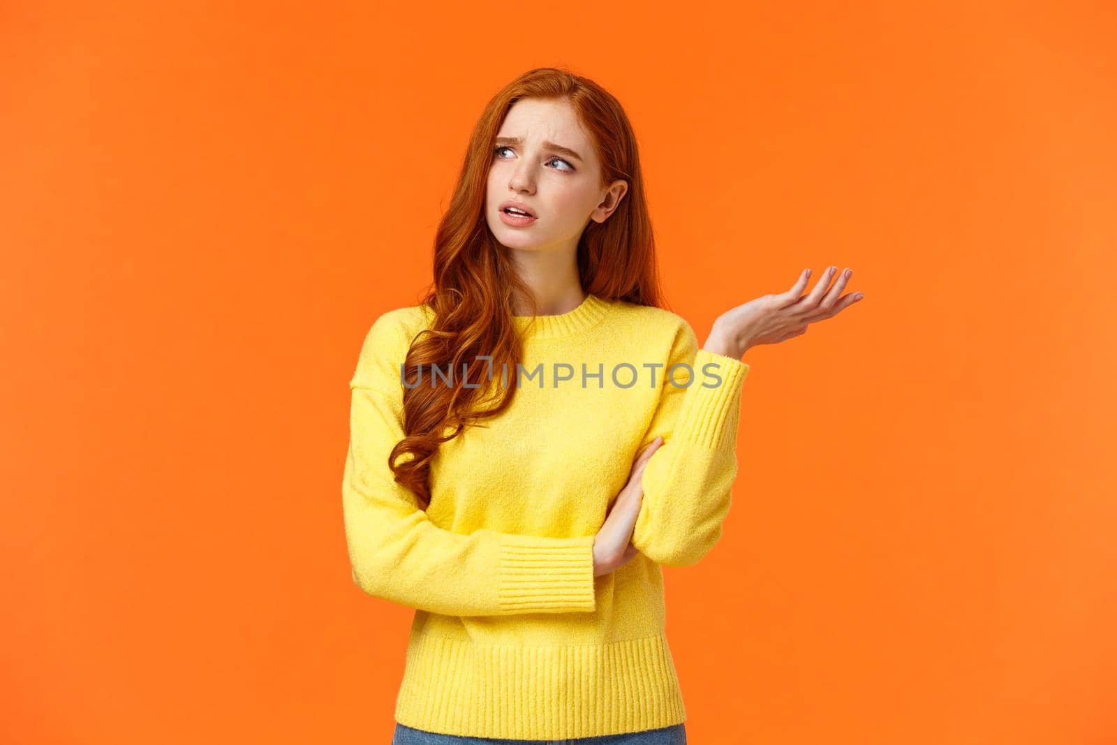 Troubled and unsure, indecisive cute redhead girl trying solve problem, searching resolve, looking perplexed upper left corner pondering, raise hand uncertain, confused, shrugging, orange background by Benzoix