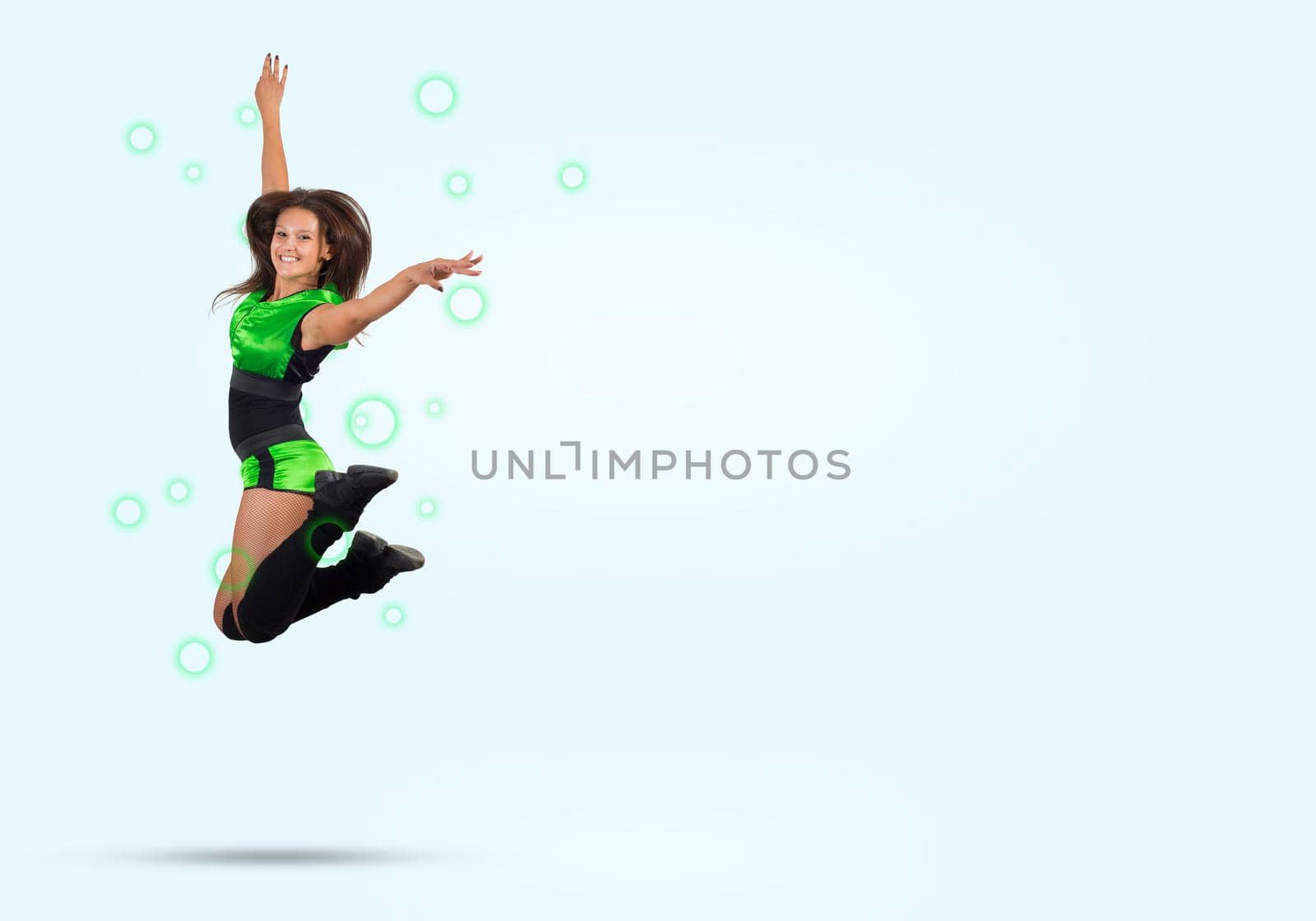 Young beautiful sporty cheerleader girl jumping high