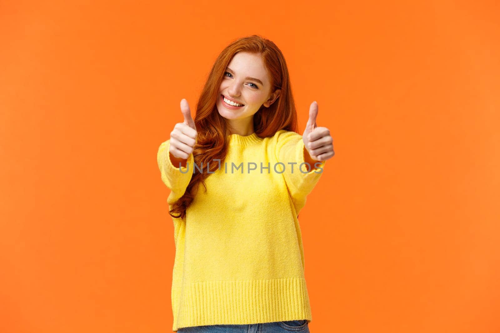 Good luck. Optimistic, confident cute redhead girlfriend encourage you, giving thumbs-up in like or approval, smiling rate excellent movie or product, give positive feedback, recomment, orange wall.