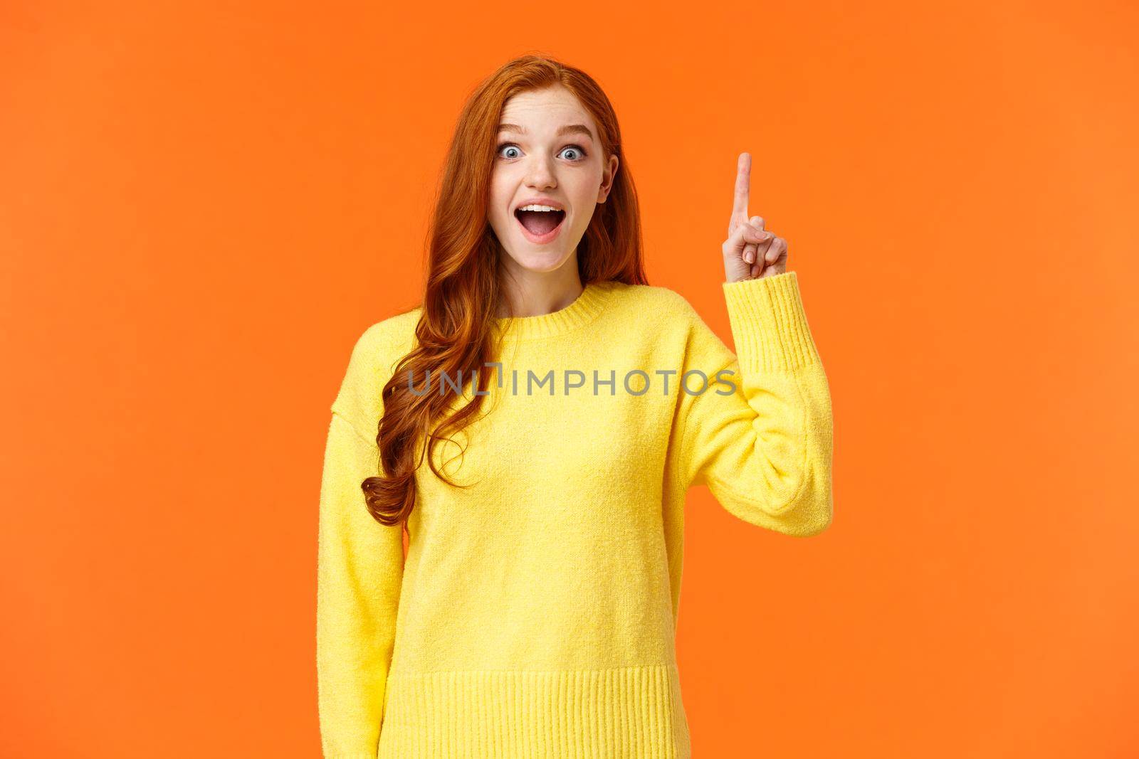 Girl have excellent idea, saying out loud. Excited cute redhead woman with curly long hair, extend index finger in air, eureka gesture and smiling astonished and happy, found solution, have plan by Benzoix